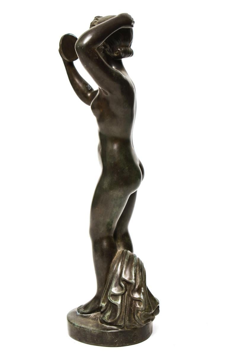 Danish Art Deco period bronze sculpture by Just Andersen (Danish, 1884-1943) depicting a female nude holding a mirror, atop a circular base. The signature is inscribed into the base and is stamped 'Denmark/D2299'. In great vintage condition with