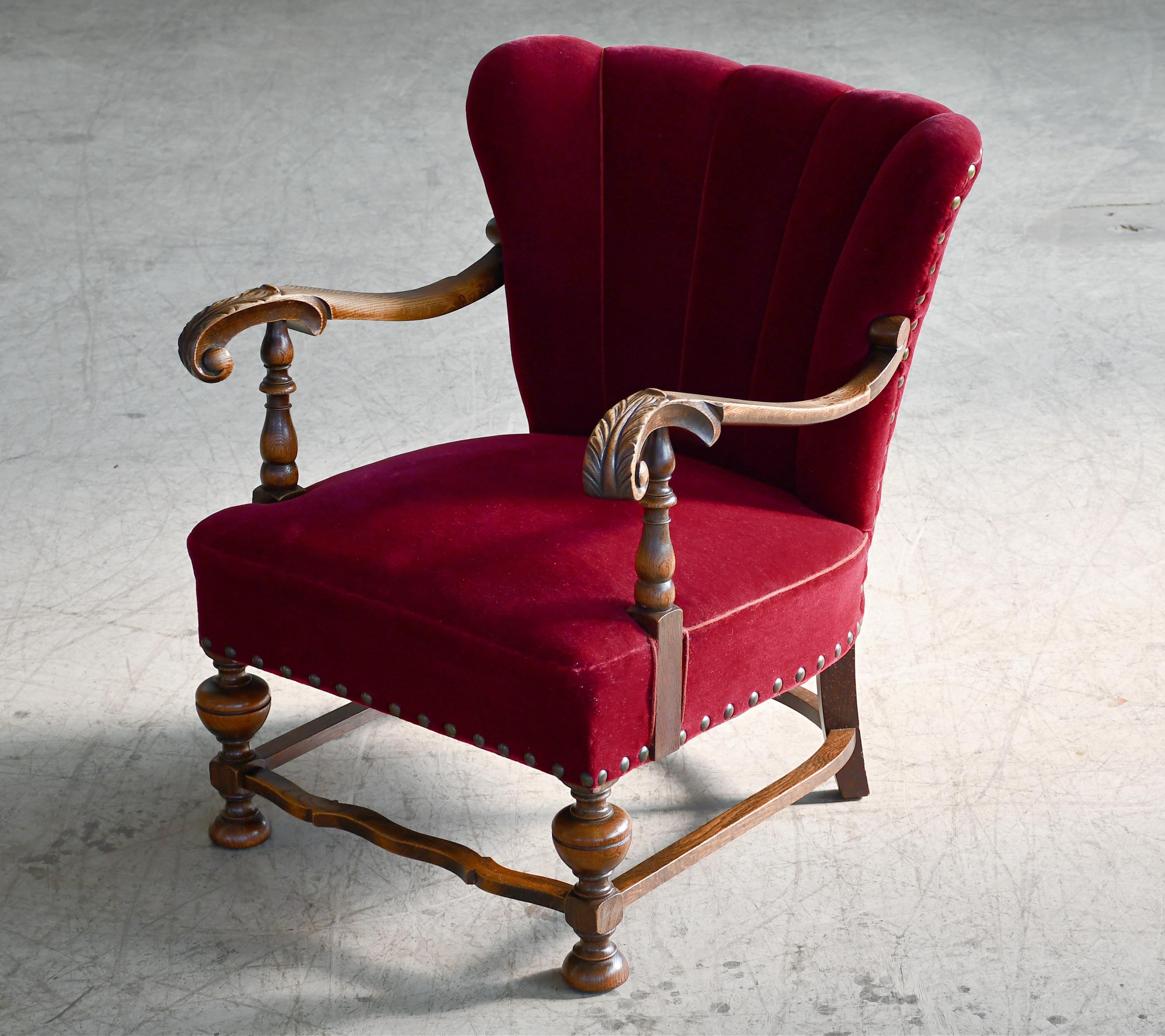 Superb Danish late Art Deco chair from the early 1930's with spring cushions and beautiful open armrests and legs carved in solid mahogany stained oak with great color and patina. We just love the simple yet very refined elegant design of this