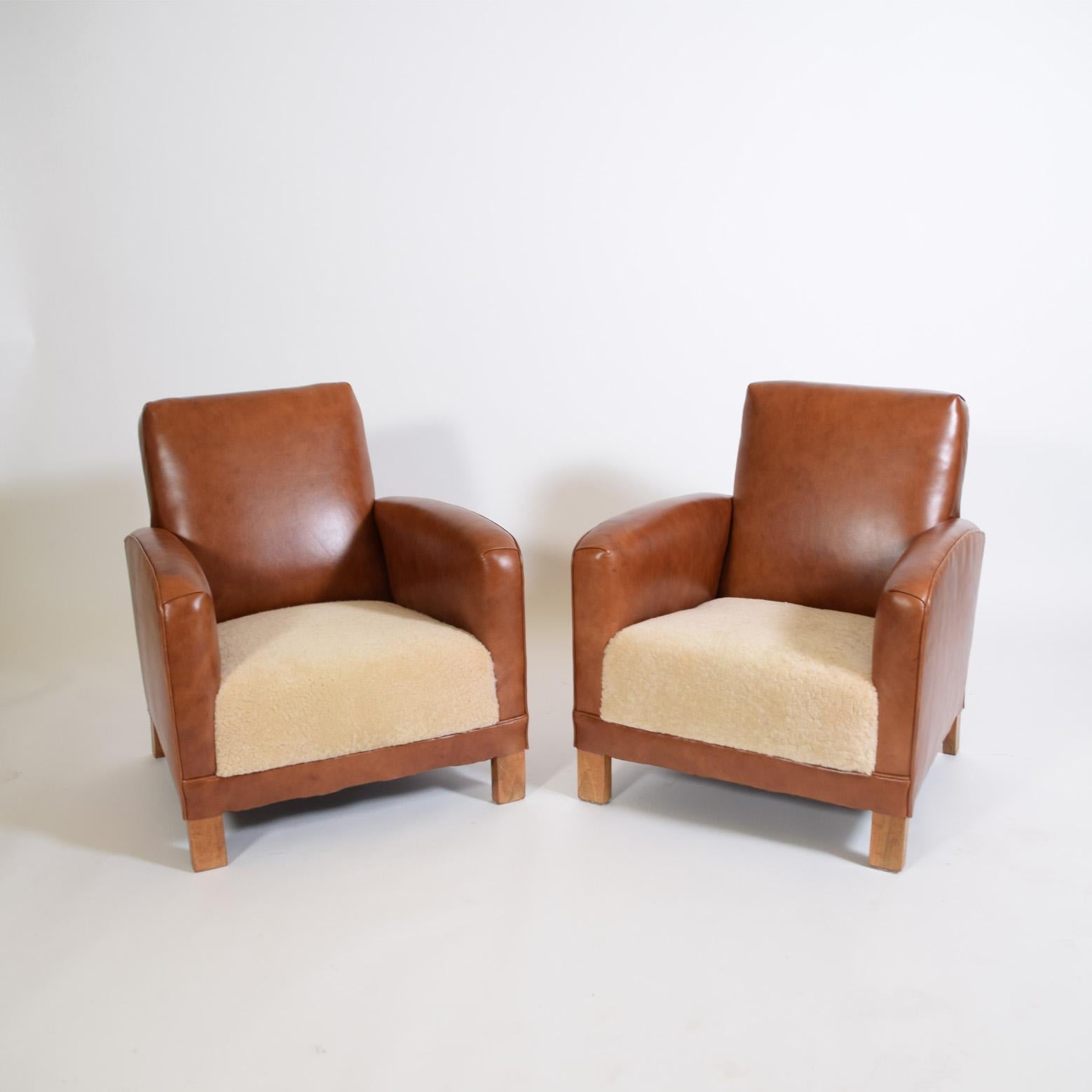 Newly upholstered leather / sheepskin 1930’s lounge chairs from Denmark solid walnut legs.