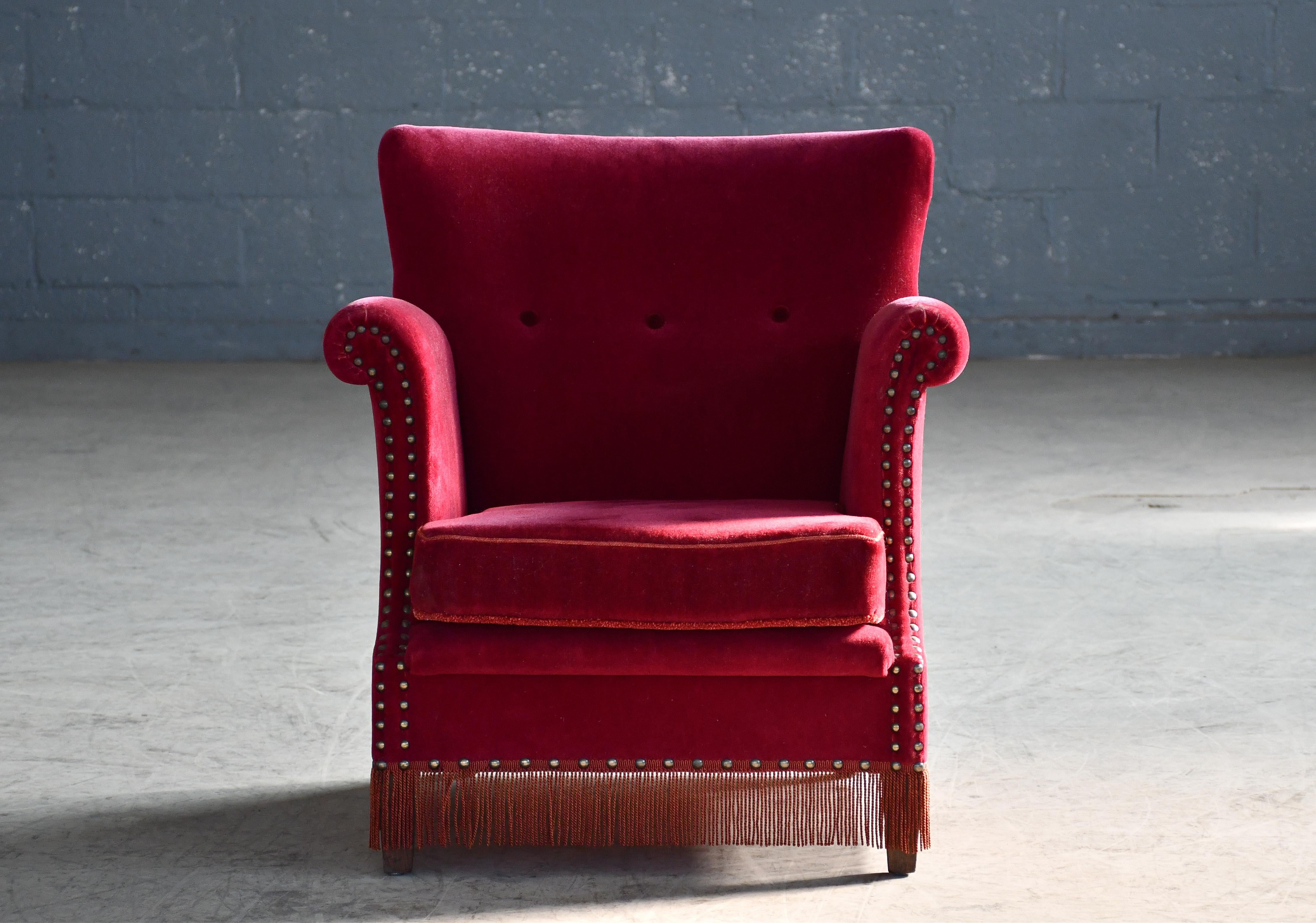 Charming and very elegant Classic Danish highback lounge chair in the style of Peter Hvidt and Orla Molgaard. Made around early 1950's. Simple yet very refined design lines and very comfortable to sit in. Beechwood frame and coil springs in the seat