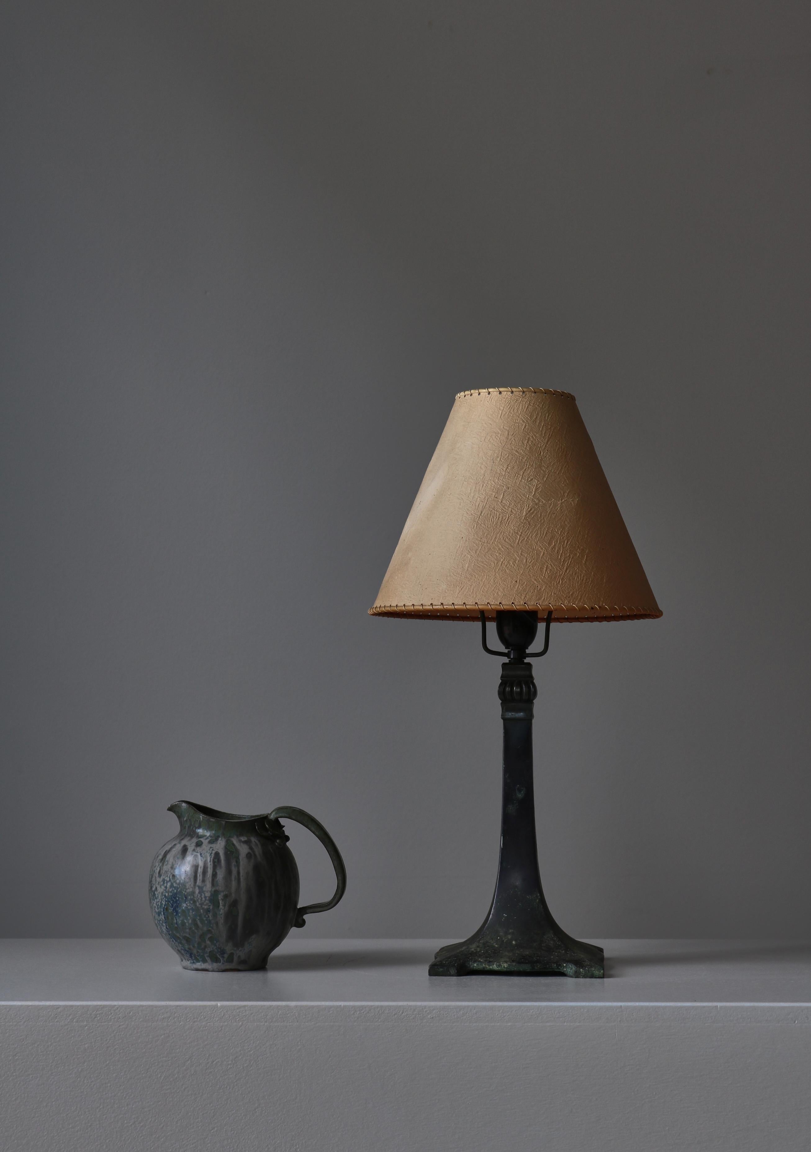Beautiful Art Deco table lamp in patinated solid bronze. Made in Denmark in the 1920s. Great quality and wear. In the style of Just Andersen. Equipped with old shade that may not be original.