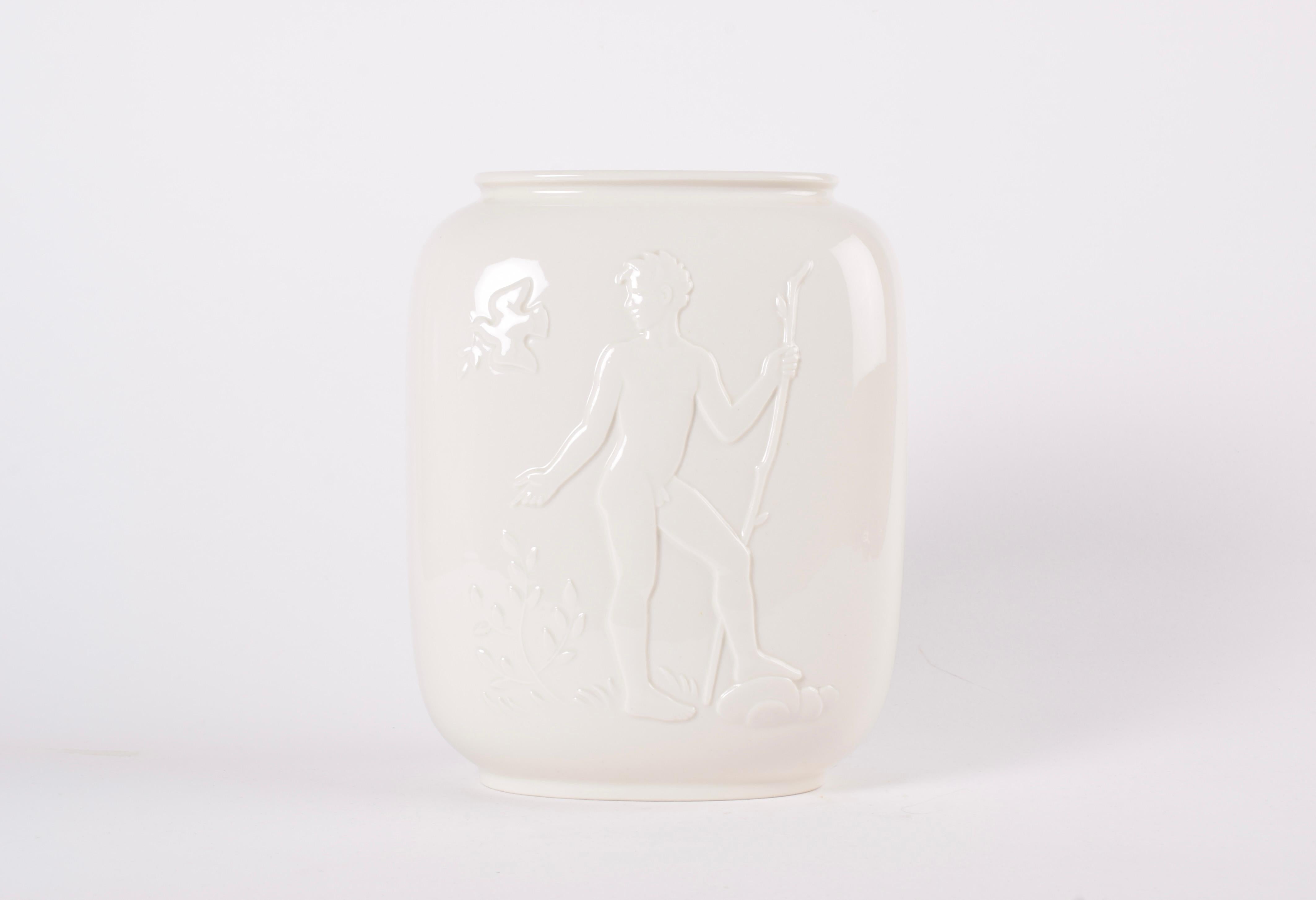 Large Royal Copenhagen Art Deco vase by Hans Henrik Hansen, manufactured 1944. Made from Blanc de Chine.

The vase features a young naked woman and man on either side surrounded by wildlife, Adam and Eve in Paradise. 

Marked under bottom with HHH