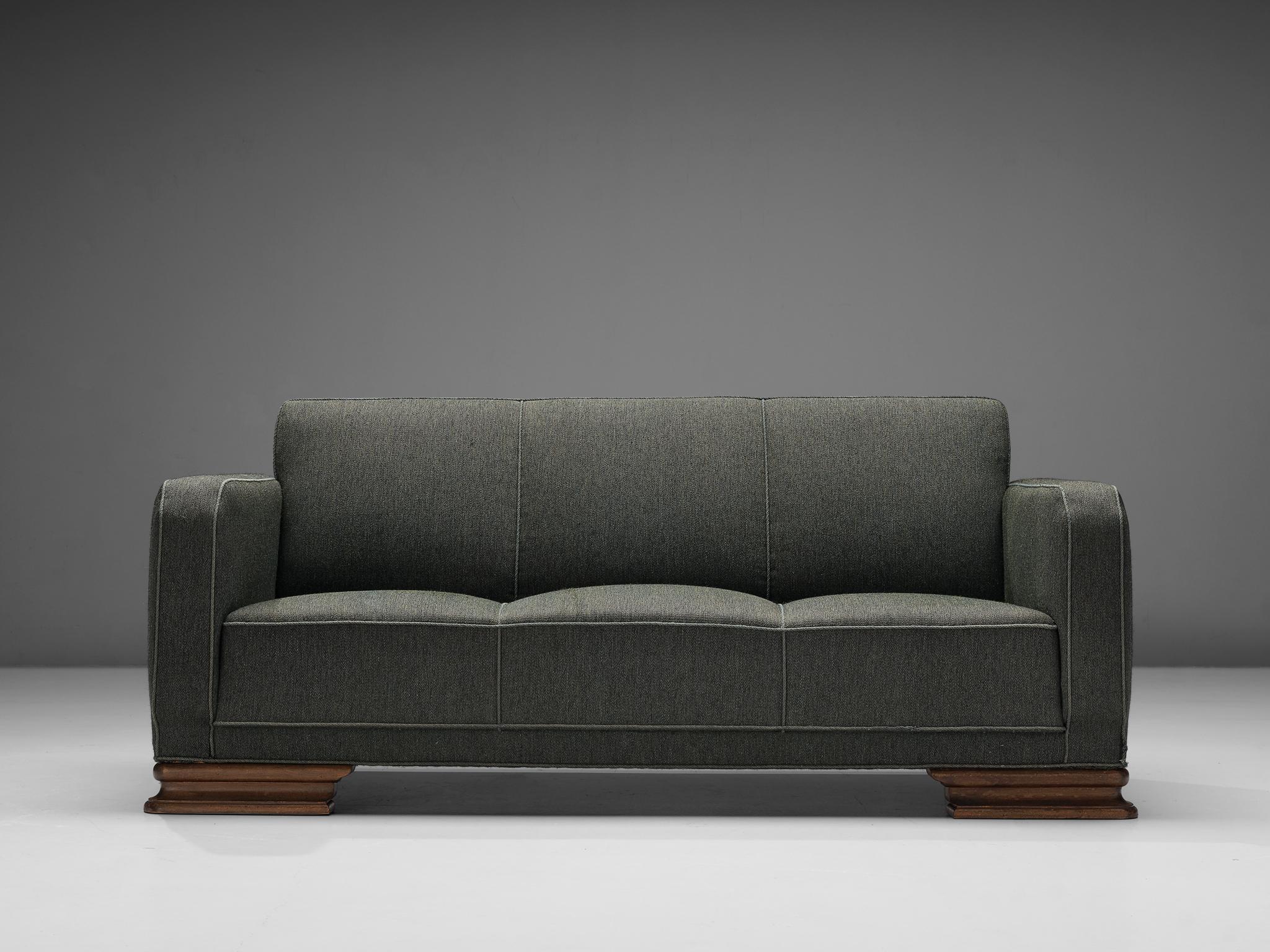 Sofa, fabric, wood, Denmark, 1940s 

This sofa of Danish origin is based on a solid construction featuring curved lines and round edges, giving the sofa character. The front legs are beautifully sculpted that allude to the stylistics traits of the