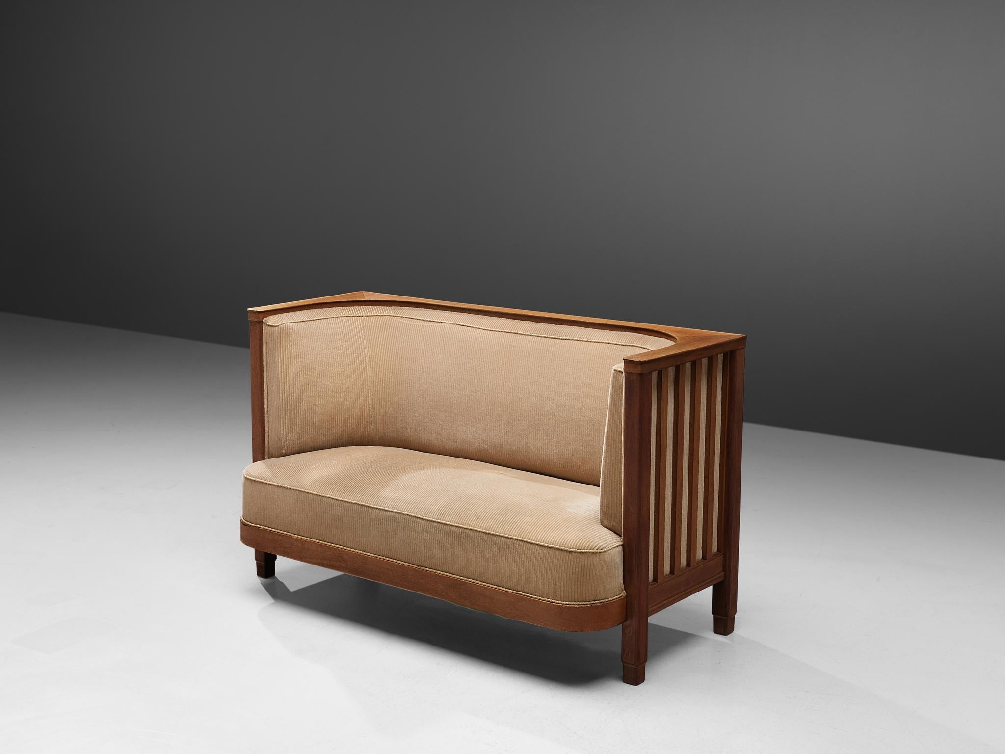 Two-seat sofa, corduroy and oak, Denmark, 1940s

A large settee with a unusual high backrest that surrounds the sitters, creating a private environment. This Art Deco sofa features strong symmetrical lines, typical for the period. The backrest