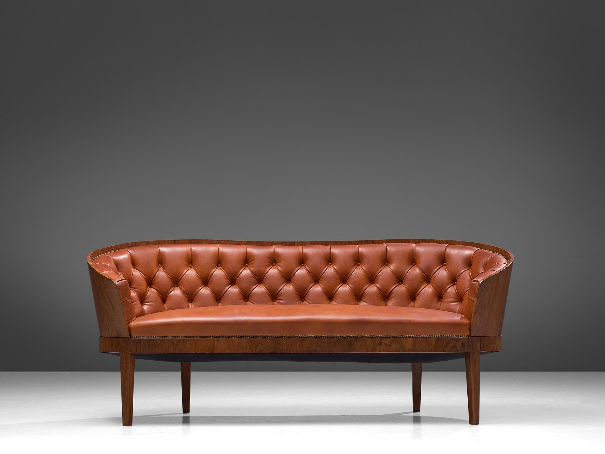 John Thorson, sofa, walnut and leather, Denmark, 1920s

A beautiful Danish sofa executed with a walnut frame and upholstered in warm red leather. What makes this sofa so special is the rounded walnut frame that surrounds the user. The leather