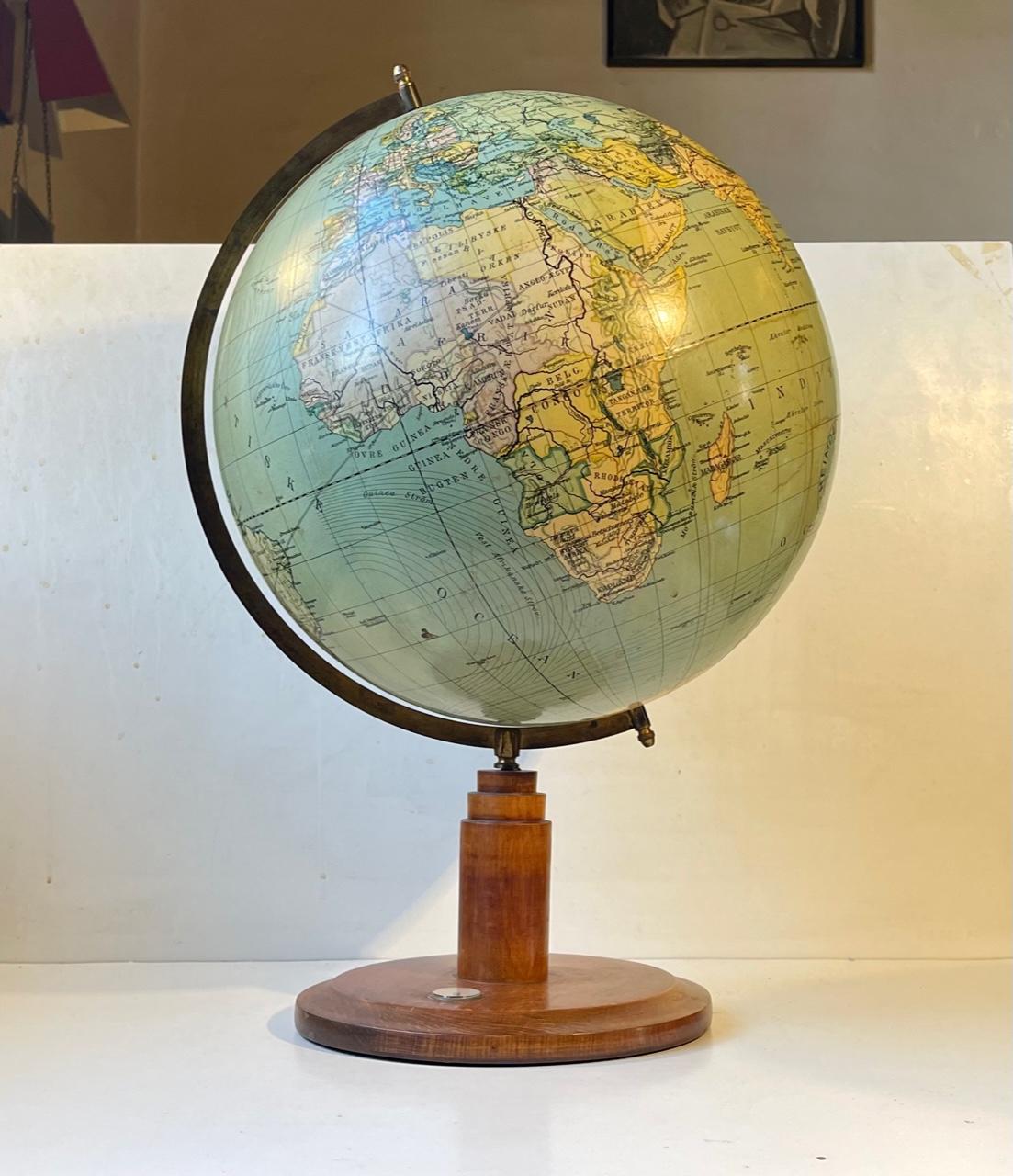 A rare surviver in shape of this 90 years old Globus. Its made from paper-covered bakelite suspended in a numbered brass frame on an Art Deco/architectural stylized wooden base with built-in compass. This is No. 34 and its scale is 1:38.000.000. It