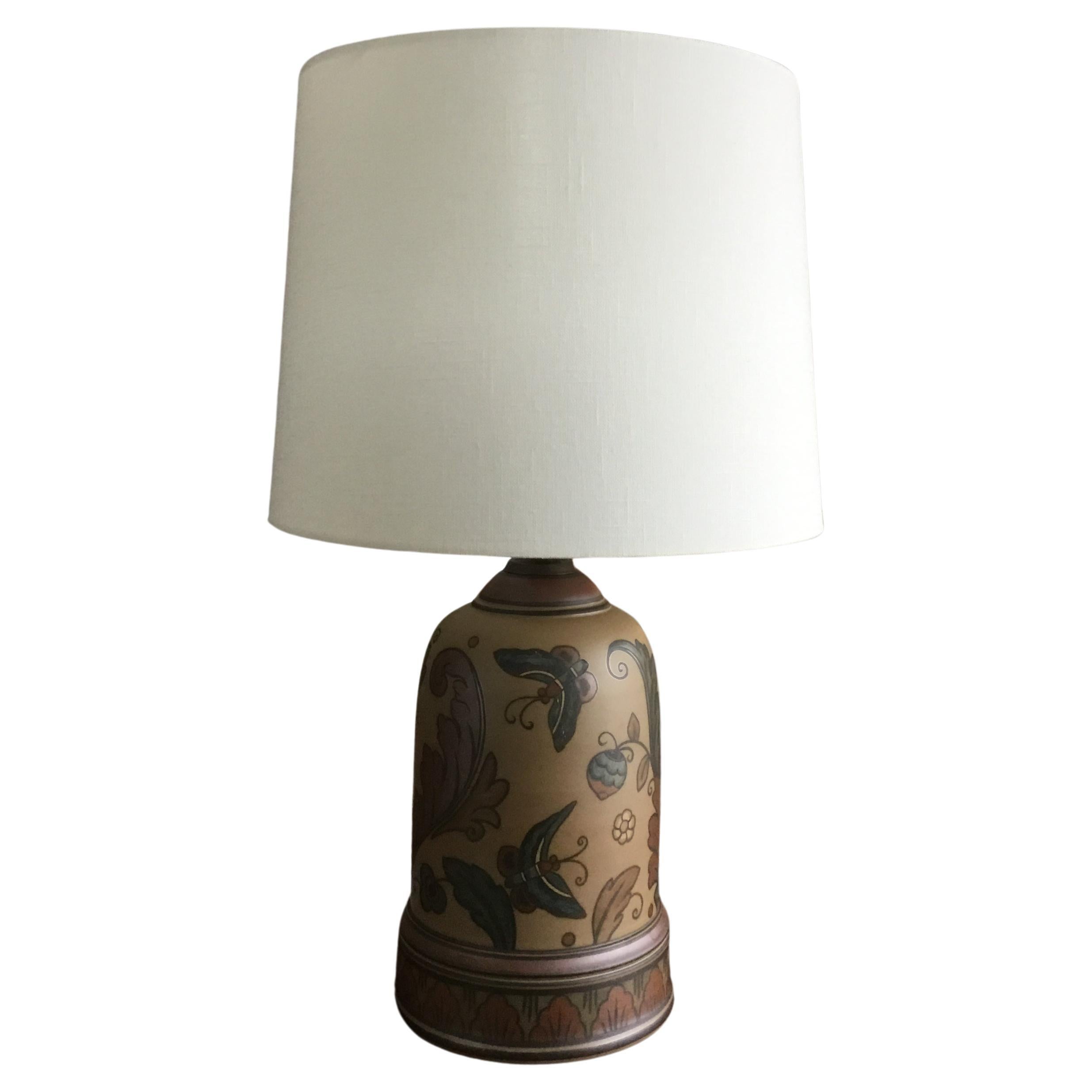 Art Nouveau table lamp by the Danish ceramic studio L. Hjorth on the island of Bornholm.
The Lamp base is made of light mocha brown ceramic decorated with leaves and butterflies. The colors of the decoration are maroon, greenish blue, brown and