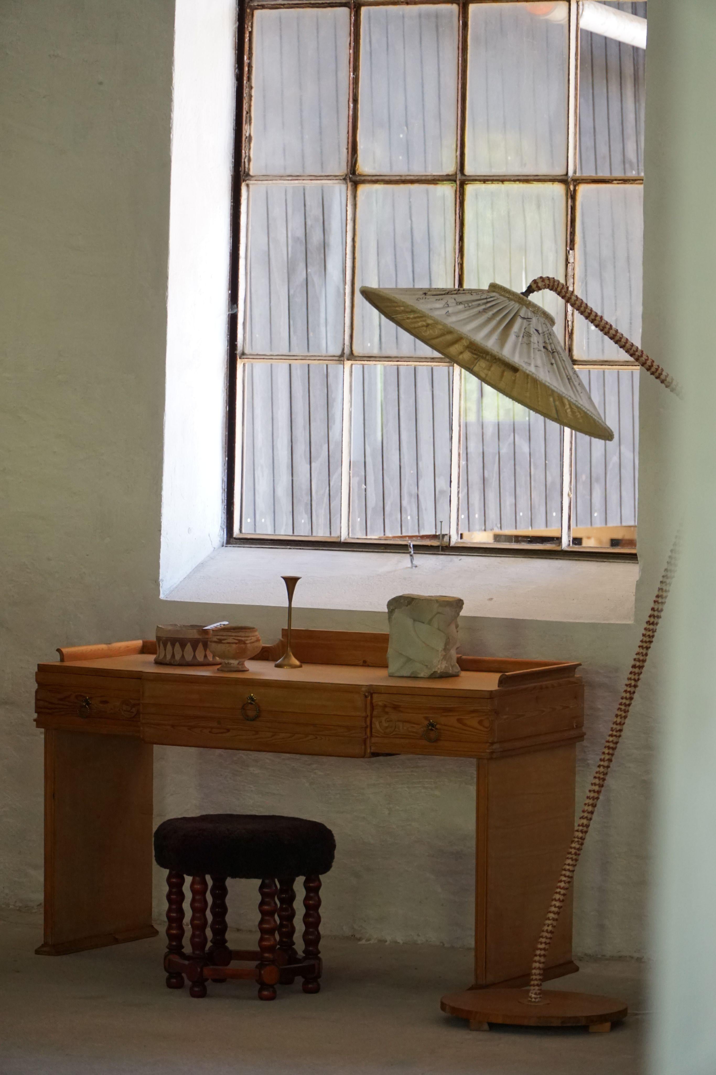 This elegant Danish Art Nouveau dressing table or writing desk, handcrafted in the early 20th century, showcases the refined craftsmanship of a Danish cabinetmaker. Constructed from solid pine, the piece reflects the naturalistic and organic