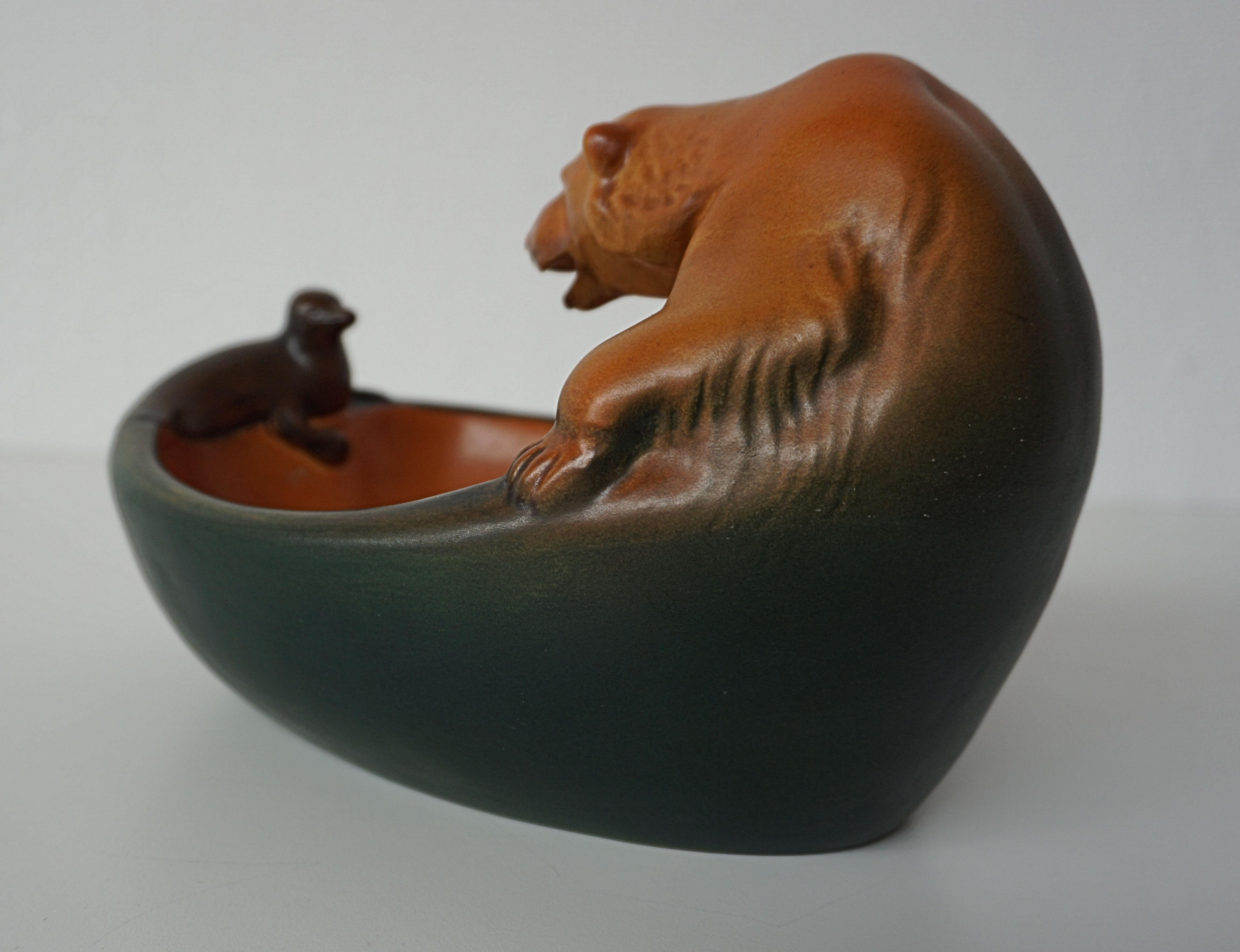 Danish Art Nouveau icebear and seal bowl designed by Charles Arvesen in 1909 for P. Ipsens Enke.

The handcrafted art nuveau bowl featureing a well made lively icebear looking at a small seal is in excellent condition.

Ipsens Enke (1843 - 1955)