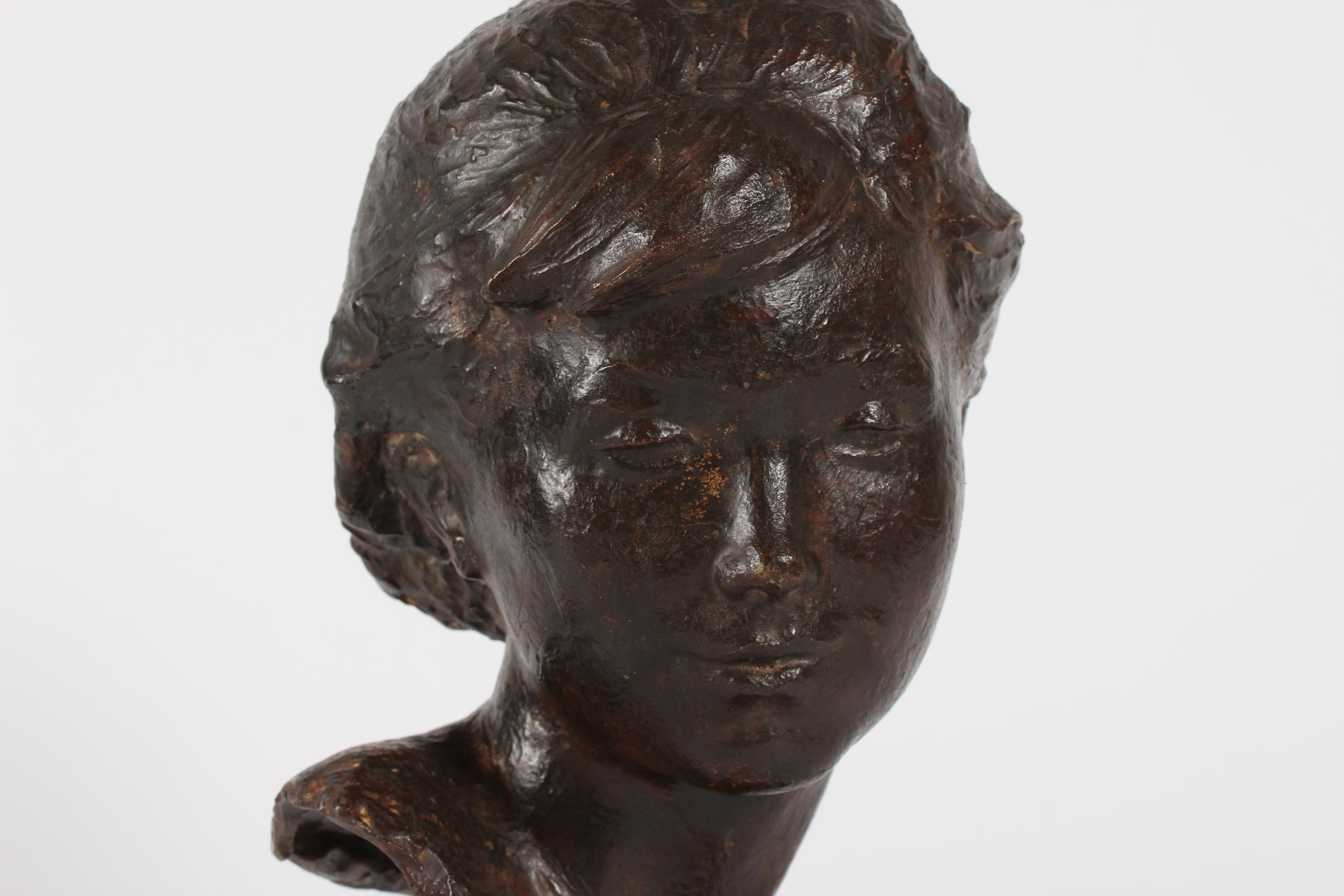 Bust of young girl by Danish artist and sculptor Anker Hoffmann (1904-1985) 
It´s made of bronze with brown patina mounted on a wooden base.
Sign. Anker Hoffmann 1963 (year of making)

Measures: Height incl. wooden base 38 cm.