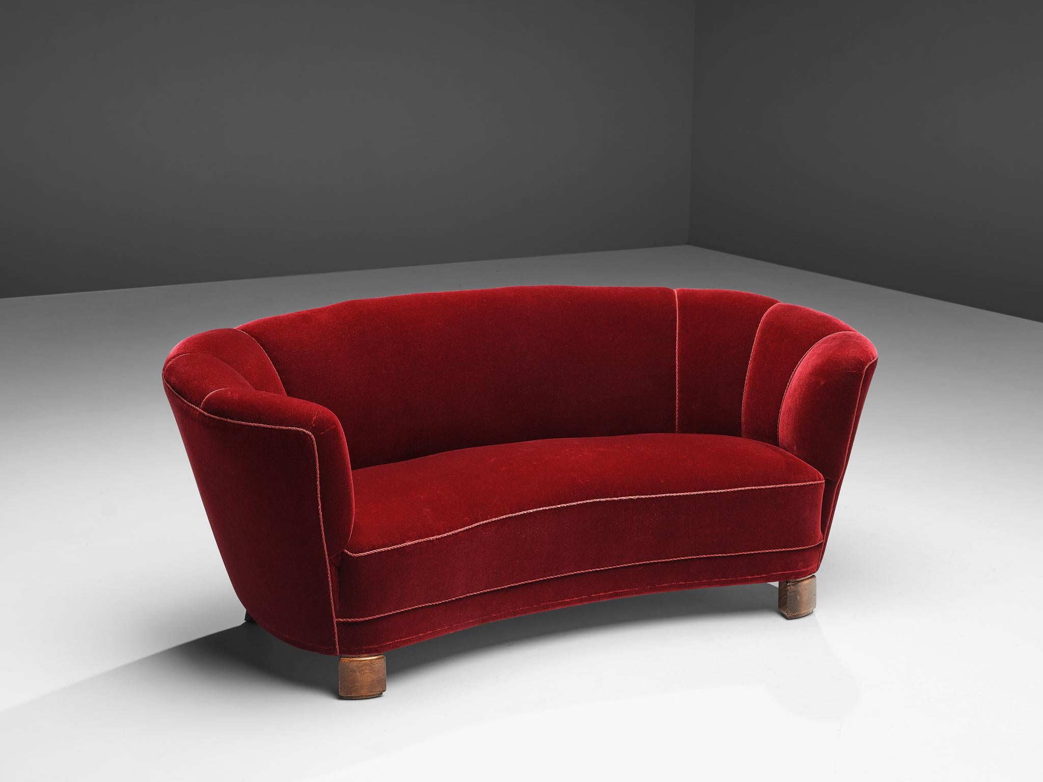 ‘Banana’ sofa, burgundy upholstery, wood, Denmark, 1940s

This voluptuous sofa is executed with a burgundy velvet upholstery. The sofa has a high lined and curved back that flows over into the bulky armrests. The sofa is slightly curved and offers a