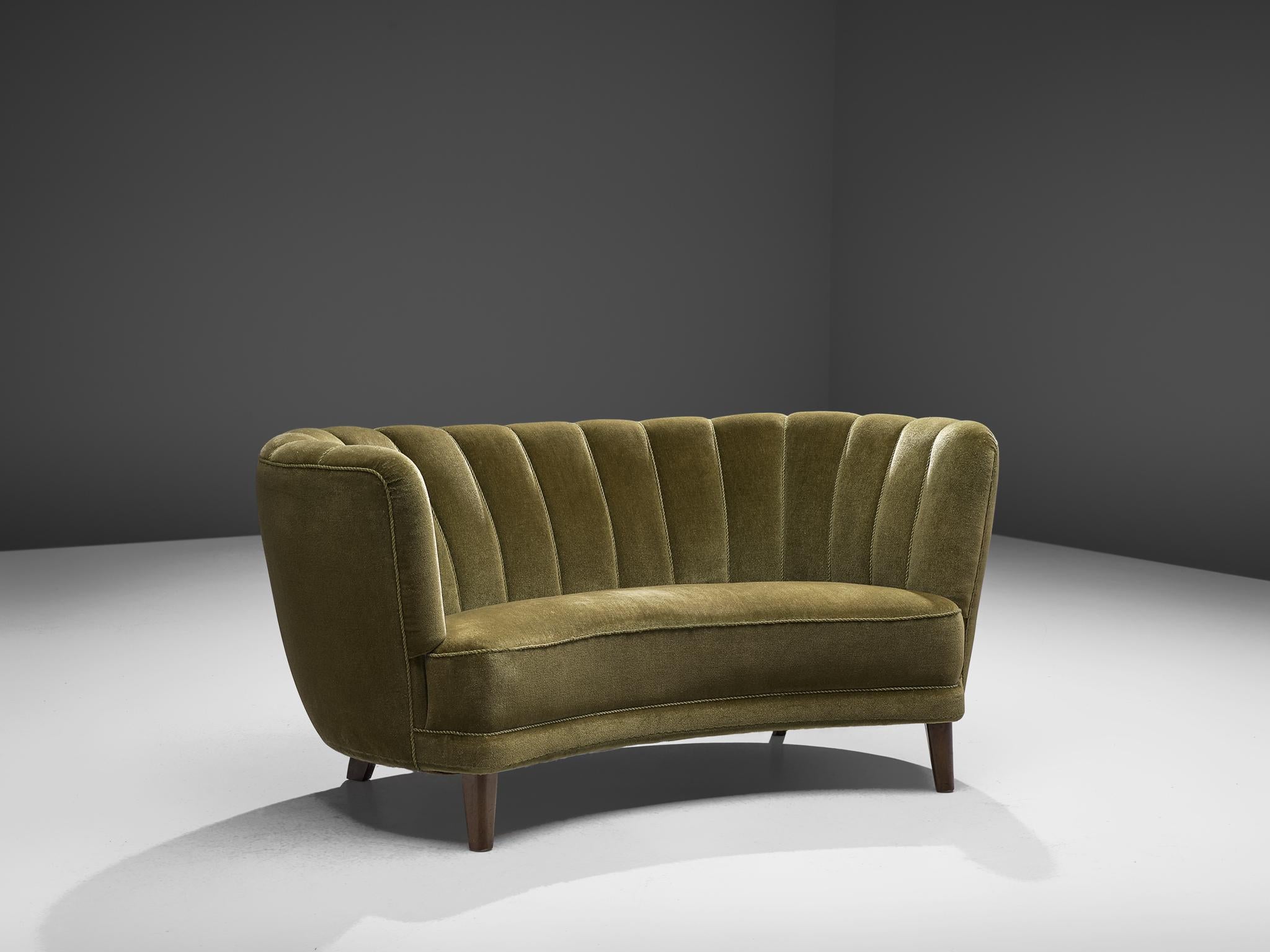 Curved settee, green fabric and oak, Denmark, 1940s

This voluptuous sofa is executed with wooden legs and a green velvet. The sofa has a high lined and curved back, while the backrest is horizontal straight and flows over into the bulky armrests.