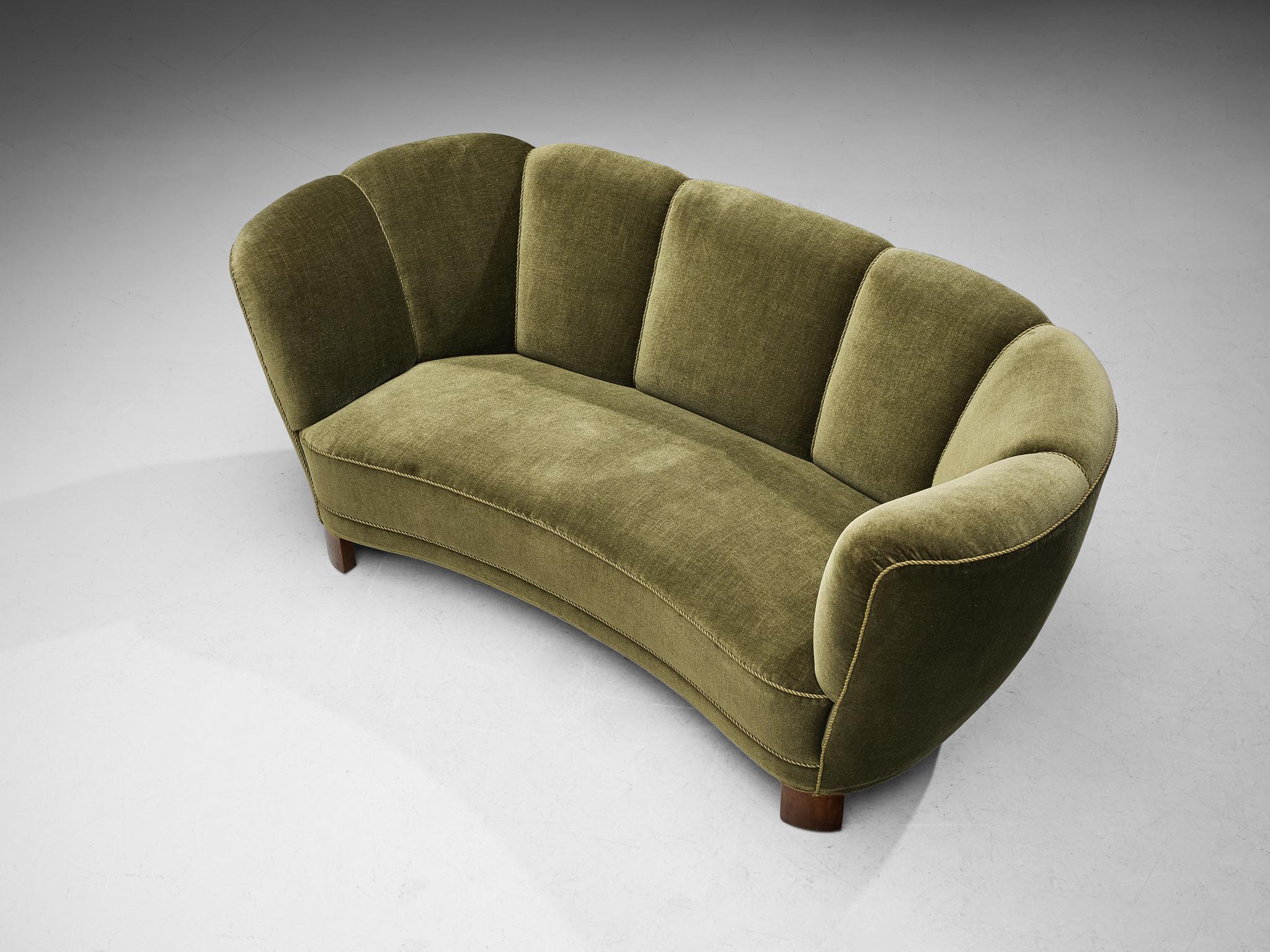 Banana sofa, velvet, wood, Denmark, 1940s

This voluptuous sofa is based on a solid construction of round shapes and curvaceous lines. The seating area and the backrest are organically shaped and together with the absence of strict angles, the