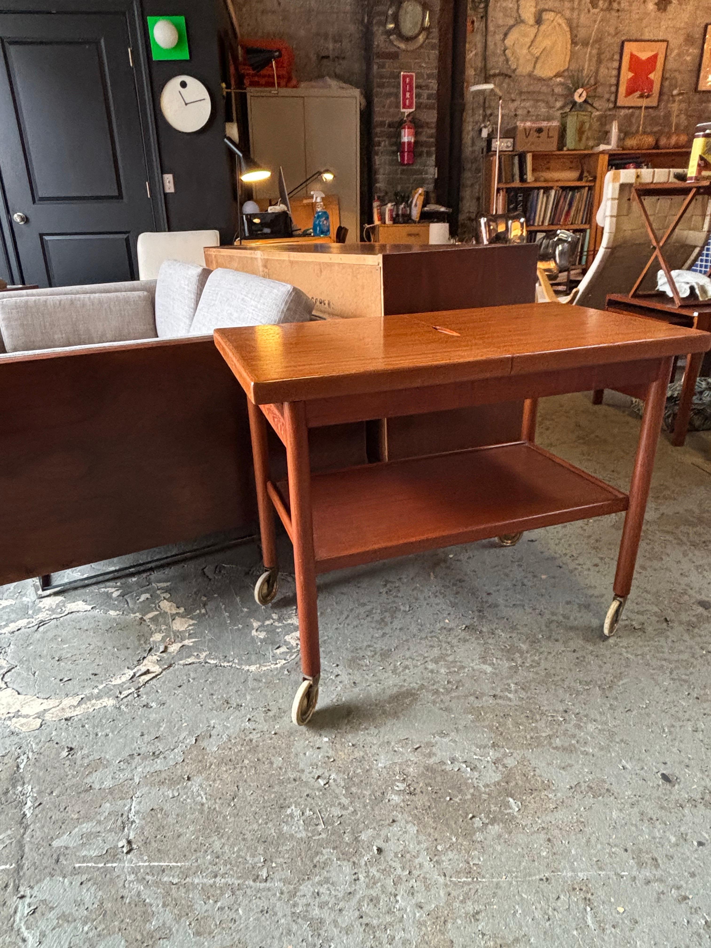 Danish Teak Bar Cart with Sliding Top that opens to reveal a black Formica work area!  Top of cart has been refinished!  Cart on wheels that make it easy to move where needed!