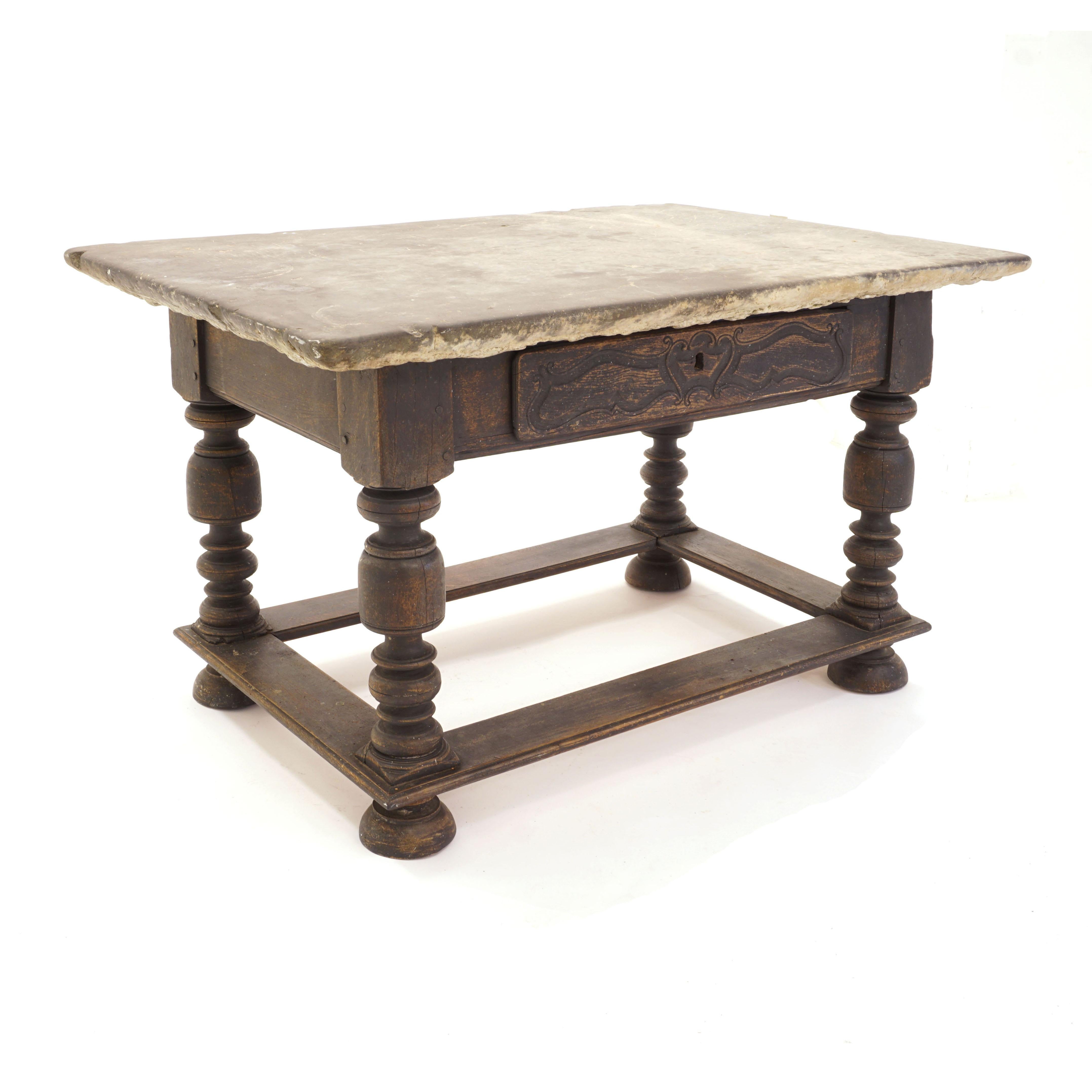 Danish Baroque stone table with grey stone top above black painted lower part
Front with drawer. Freestanding.