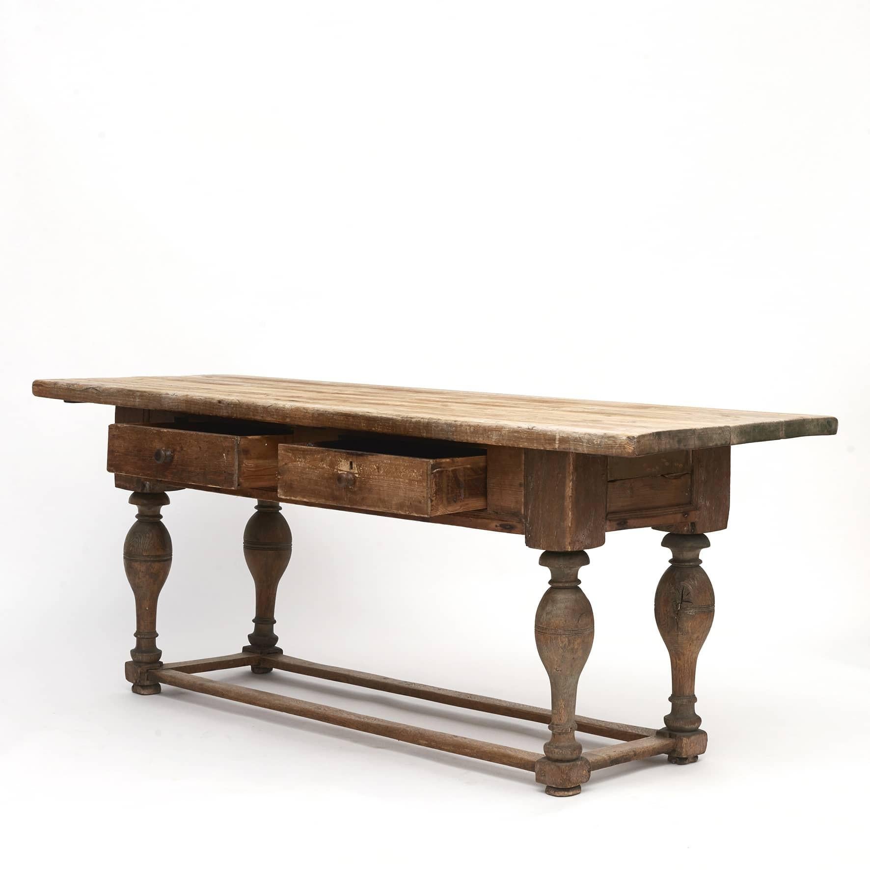 Danish Baroque table approx. 1750.
Pine table top, apron and drawers. Legs in oak with a box stretcher base.
Raw style with a good expression.

Original condition.