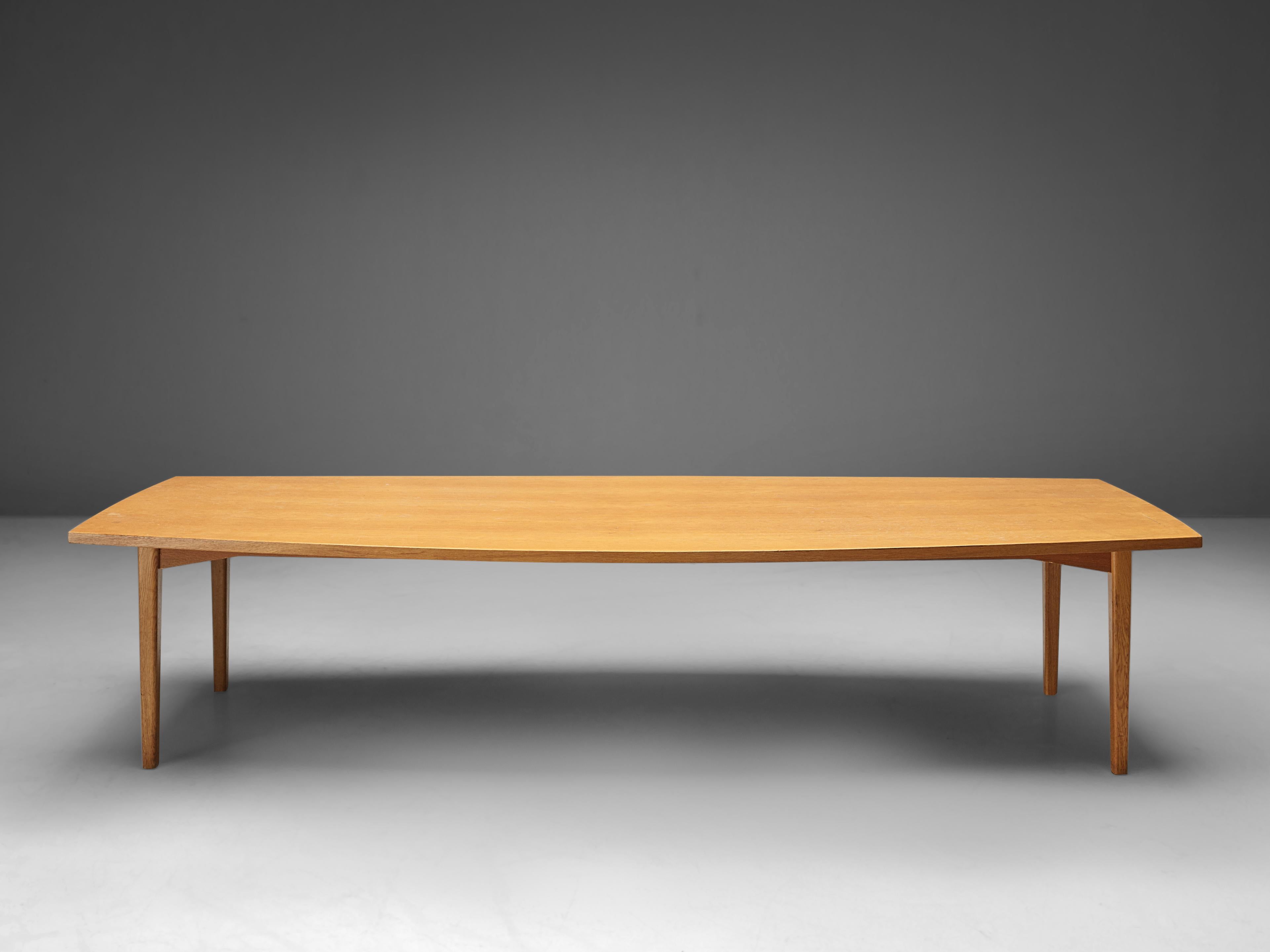 Conference table, oak, Denmark, 1950s.

A 3.3 meter / 130 inch large dining table in oak. The barrel-shaped tabletop is made out of one piece, featuring a beautiful grain. The base consists of four slender rounded rectangular legs that make the
