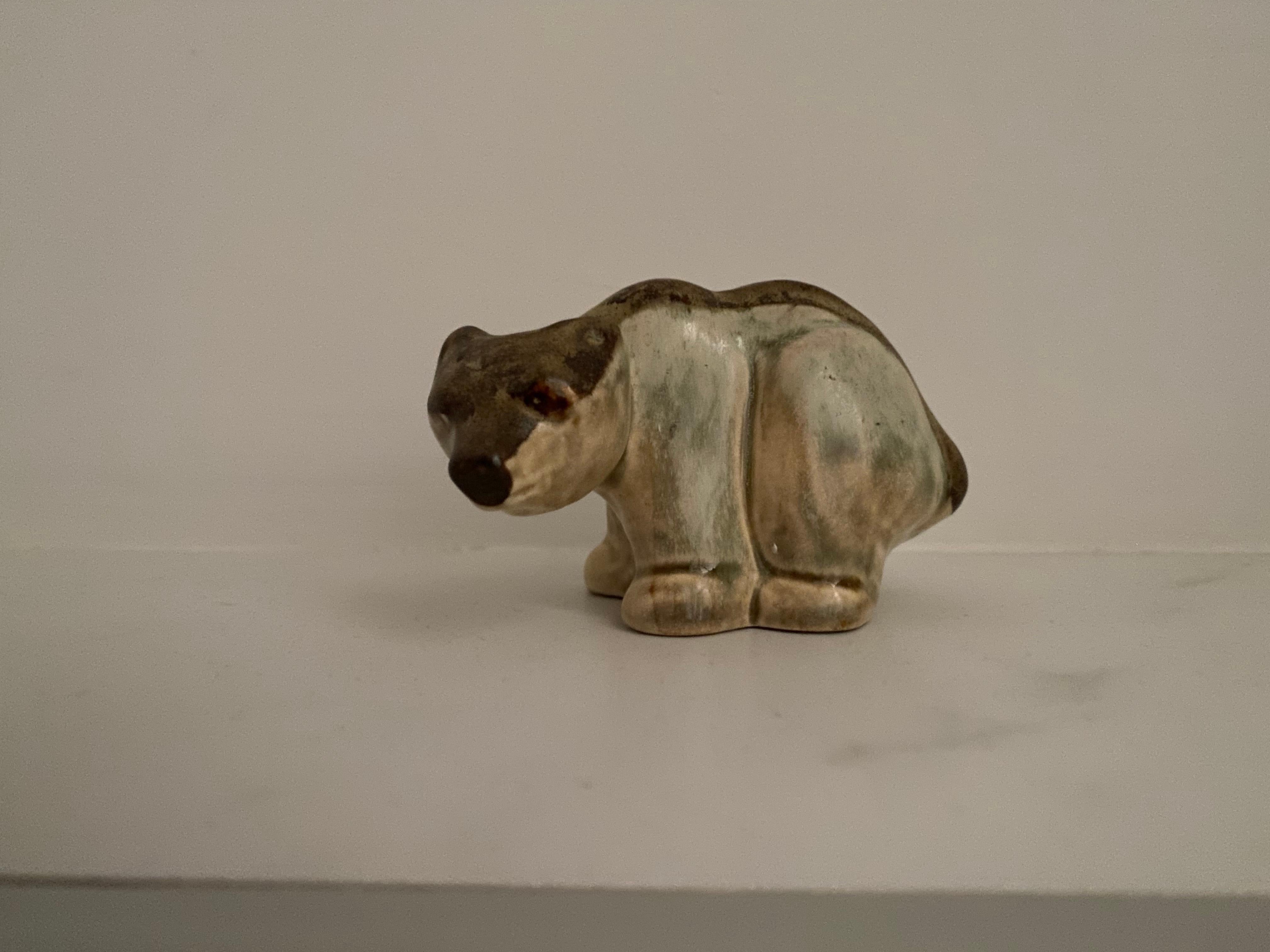 Nice stoneware animal figurine of a bear by Soholm Pottery Denmark.

This sculpture was made by Joseph Simon.
The name of the factory is stamped on the bottom.