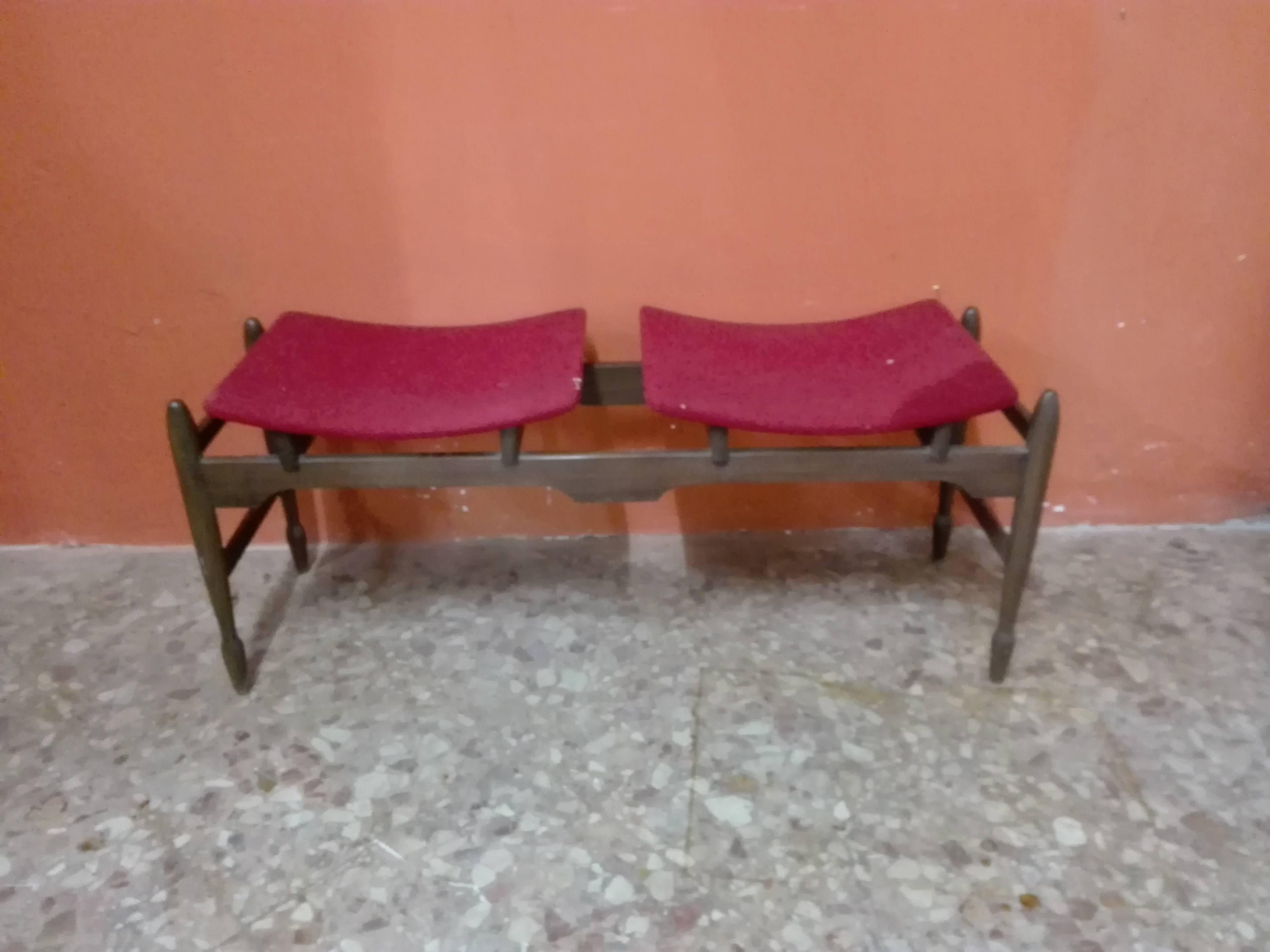 Two-seat bench with monomaterial and one-color coating, fabric covering, removable feet to facilitate shipping.
