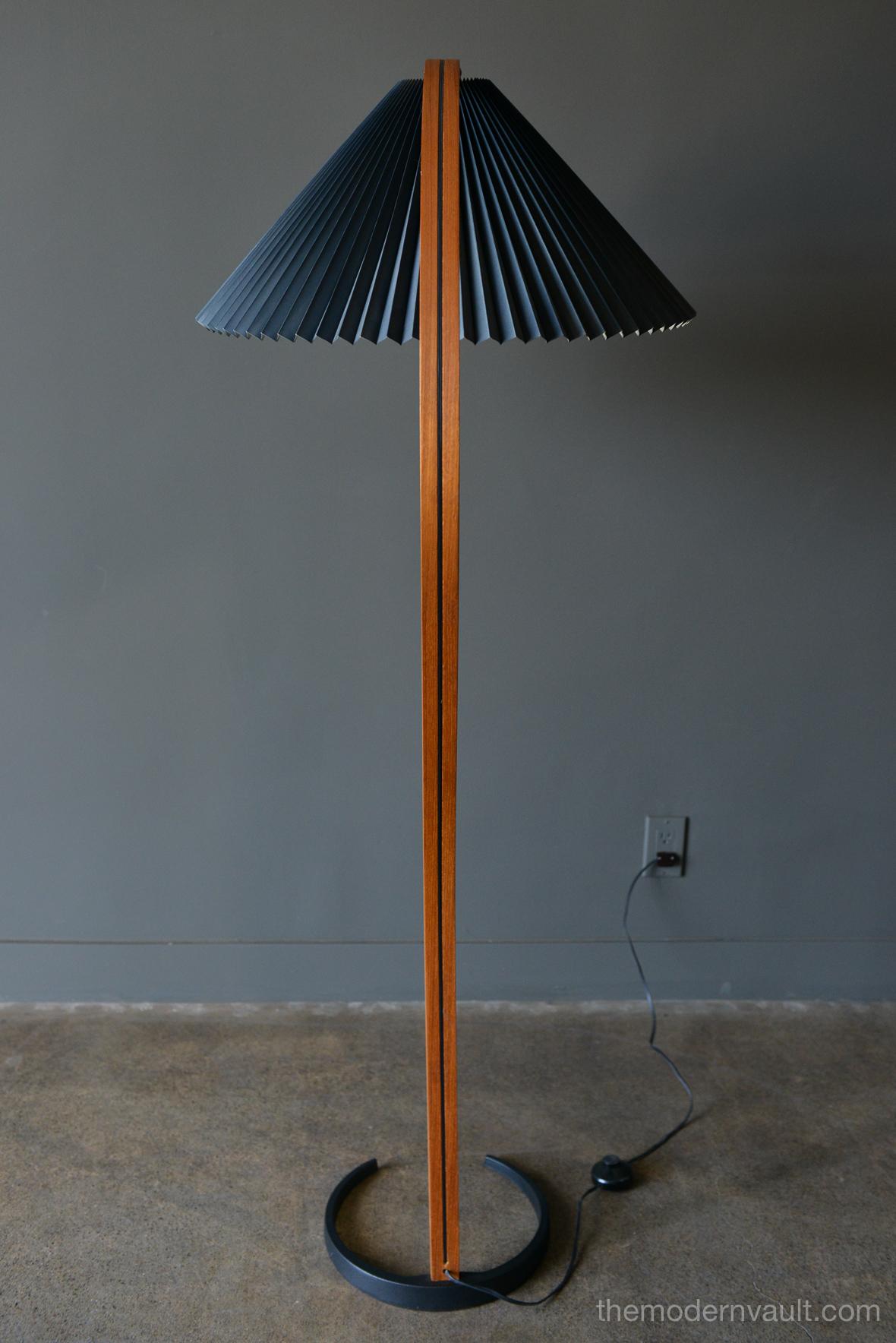 Danish bentwood floor lamp by Mads Caprani lamp, circa 1970. Original condition with black shade. Beautiful bentwood frame with pleated black shade. Original floor switch and cast iron base. Measures 60