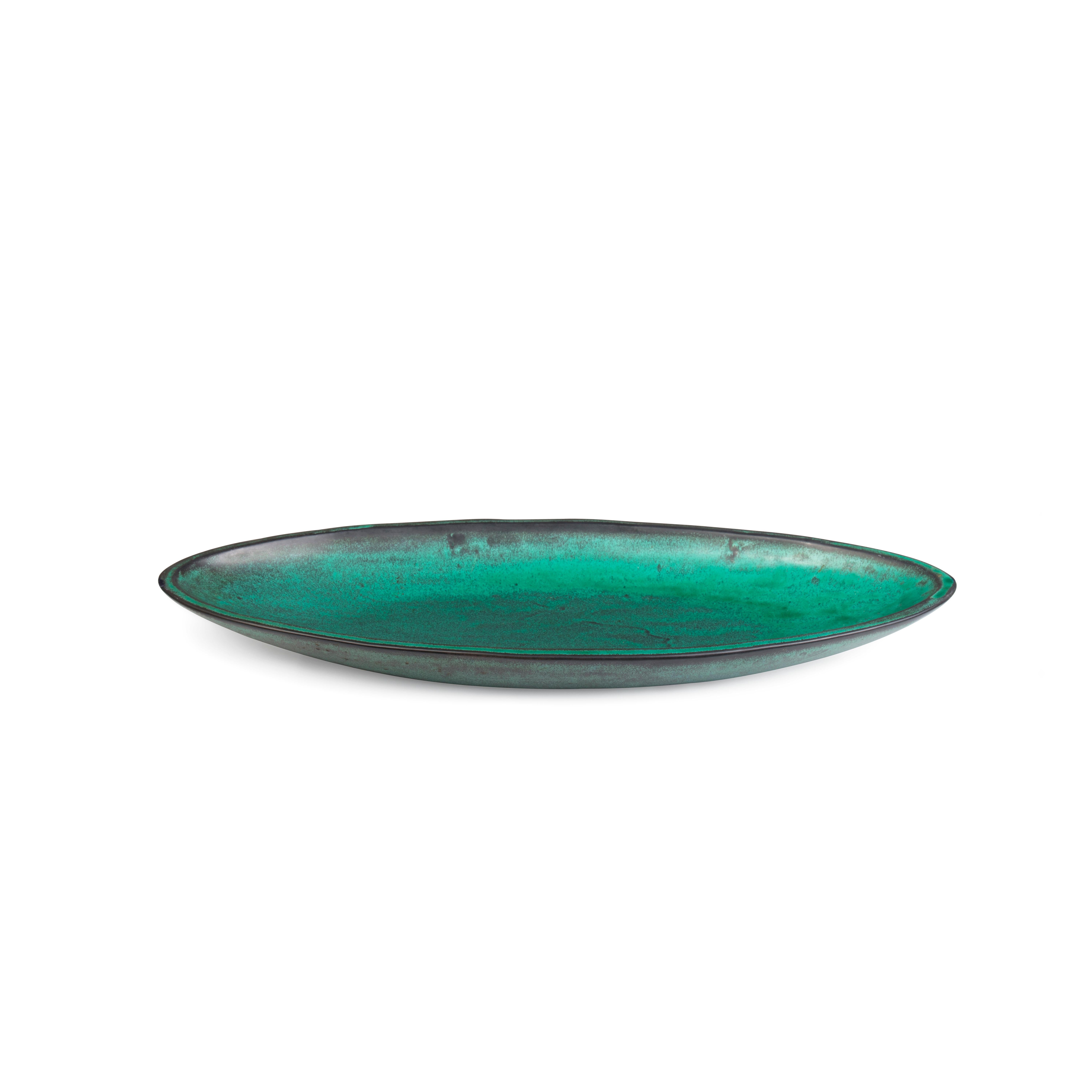 This very large elliptical shaped earthenware dish designed by Nils Kähler (1906-1979) was executed by Herman A. Kähler, Denmark, ca. in the 1940s.

It is decorated with black and turquoise green double glaze.

The dish is incised with the ‘HAK’