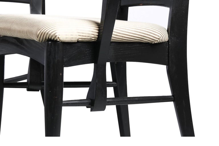 An outstanding set of four dining chairs in black frames, designed by Niels Koefoed for Koefoeds Hornslet, model “Lis” made in Denmark, circa 1960s. This stunning set of four ladder back chairs feature two arm chairs and two side chairs in original
