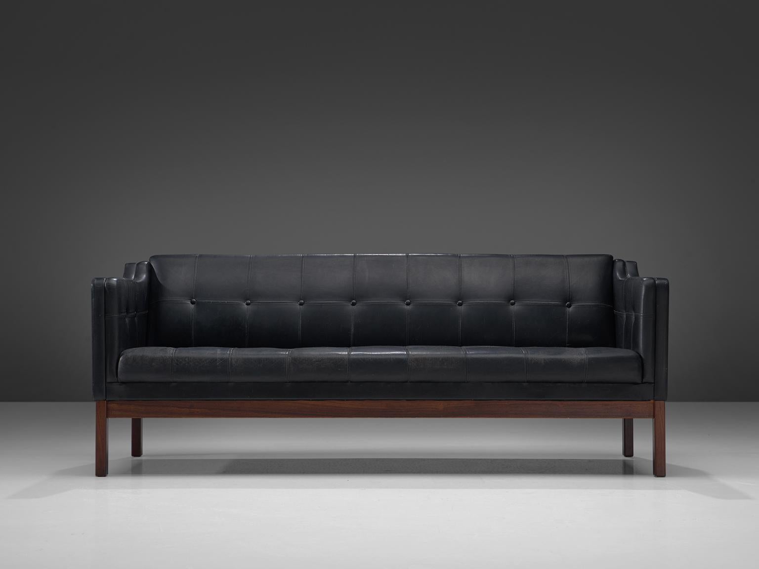 Pastoe, three-seat sofa, leather and rosewood, The Netherlands, 1960s

Elegant sofa manufactured by Pastoe in the 1960s. The rosewood frame holds a black leather buttoned body. The sofa features a well balanced design, showing strong influences of