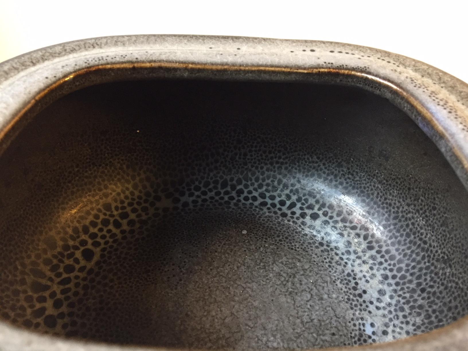 The model number 22346 refers to the shape of the bowl. The black, grey and earthy glazes applied are made by hand and unique to this piece. It was designed by the Danish ceramist Eva Stæhr-Nielsen between 1969-1974 as indicated by the makers mark.