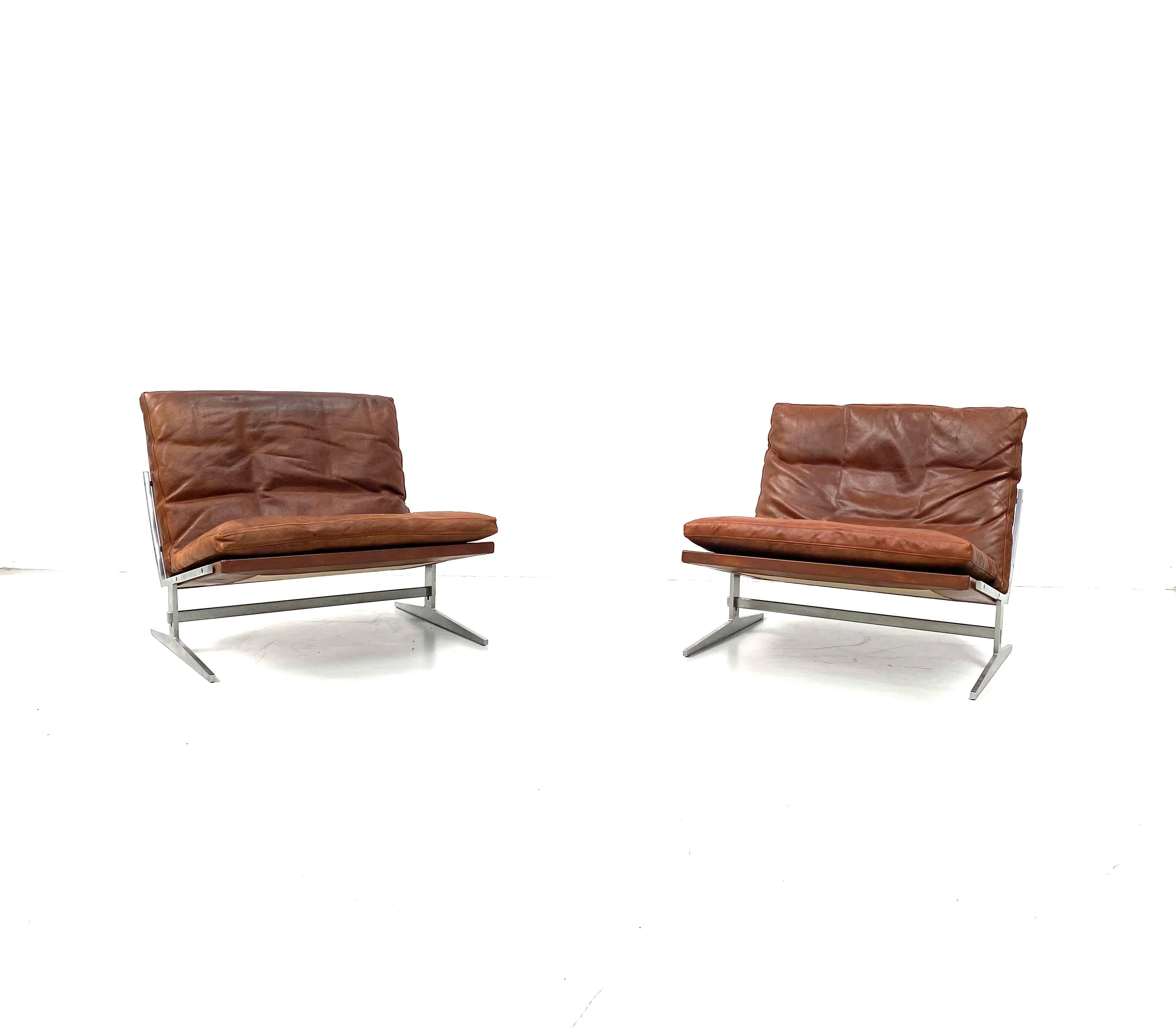 These set of 2 BO-561 Lounge chairs are designed by Preben Juhl Fabricius and Jorgen Kastholm in the sixties. 
The 2 Danish designers met each other in the 50s but start only working together in the 60s. While Fabricius was an educated cabinetmaker