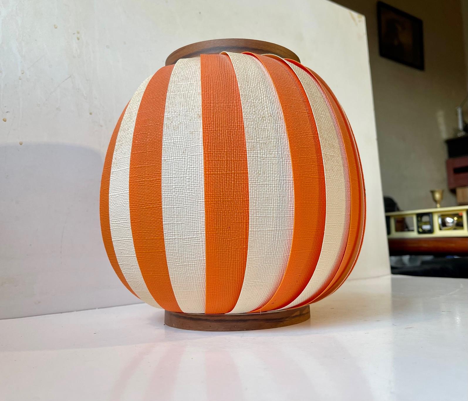 A bonbon striped acrylic pendant lamp called Bojan or Cocoon. This striped version is rare and it was designed by Lars E. Schiøler and manufactured by Høyrup in Denmark during the late 1950s or early 60s. Similar designs surfaced from Le Klint,