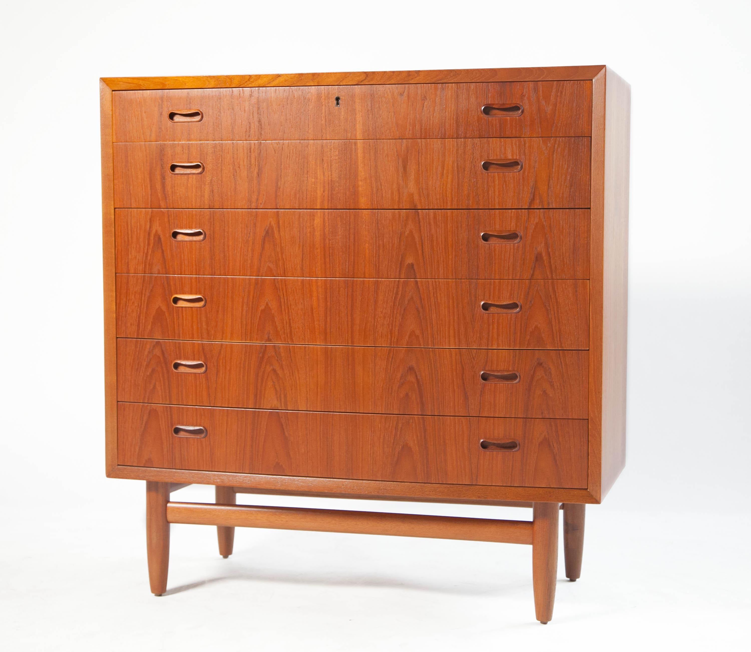 Bow front Teak dresser, circa 1960's. 6 drawer dresser features solid wood edging with stunning book-matched veneer on all drawer faces and dovetail construction. Graduated drawer design allows larger items to be stored in the bottom drawers while