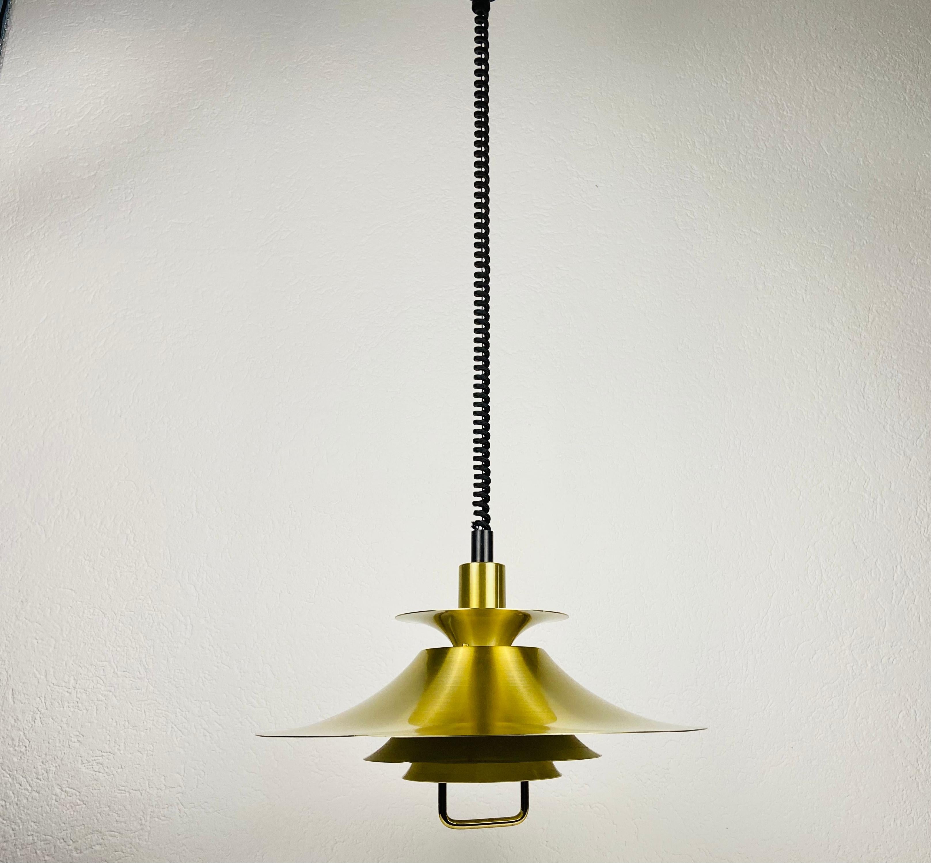 Danish brass and metal pendant lamp made in Germany in the 1960s. The fixture gives a very beautiful light. It is made from thin aluminum and brass.

Measurements:
Height 73-135 cm
Diameter 48 cm

The light requires one E27 light bulb. Works