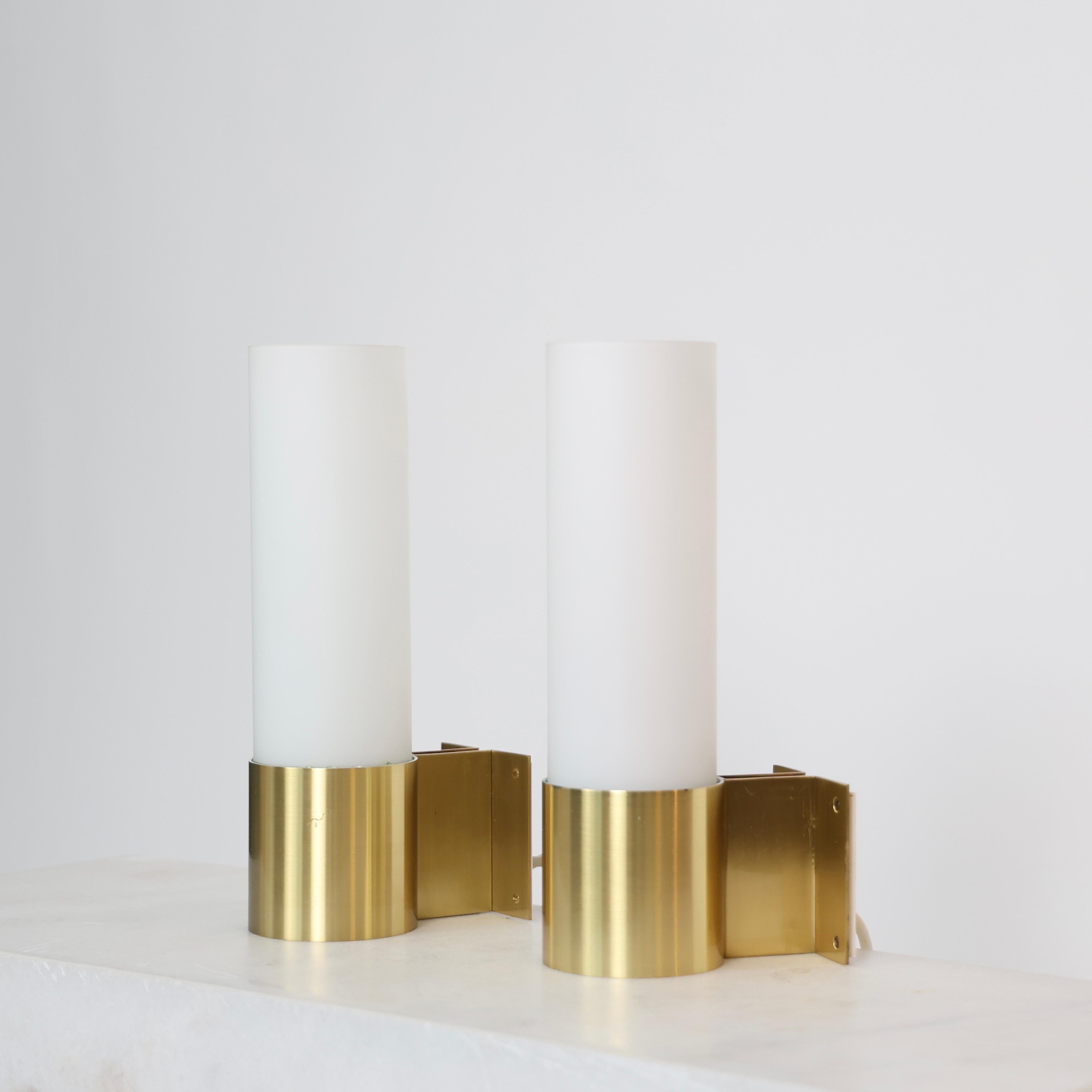 Set of Brass & Opaline Glass Sconces in very good condition designed by Jørgen Bo for Fog & Mørup in 1968. 

* Set (2) of brass sconces with white mouth-blown opaline shades
* Designer: Jørgen Bo
* Model: Bo
* Producer: Fog & Mørup 
* Year: 1968
*