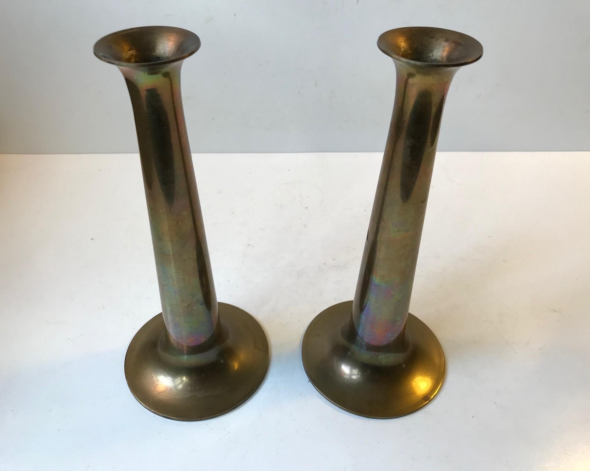 This pair of candlesticks was designed by Hans Bolling and manufactured by Torben Ørskov in Denmark during the 1960s. They are made from solid brass and feature the manufacturer's mark to each base. Please notice the beautiful rainbow patina they