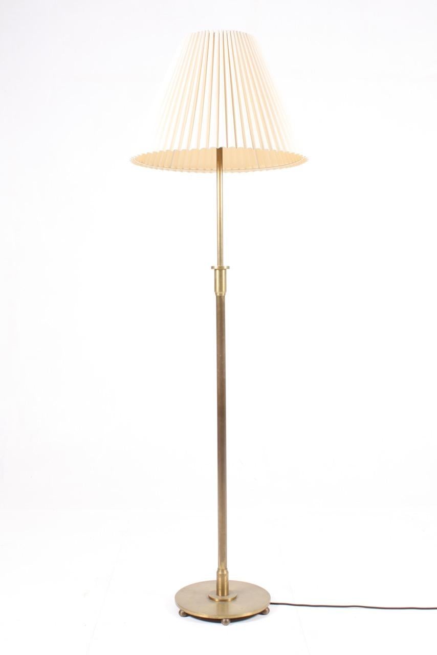 Danish floor lamp in solid patinated brass. Designed and made in Denmark in the 1940s. Great quality.