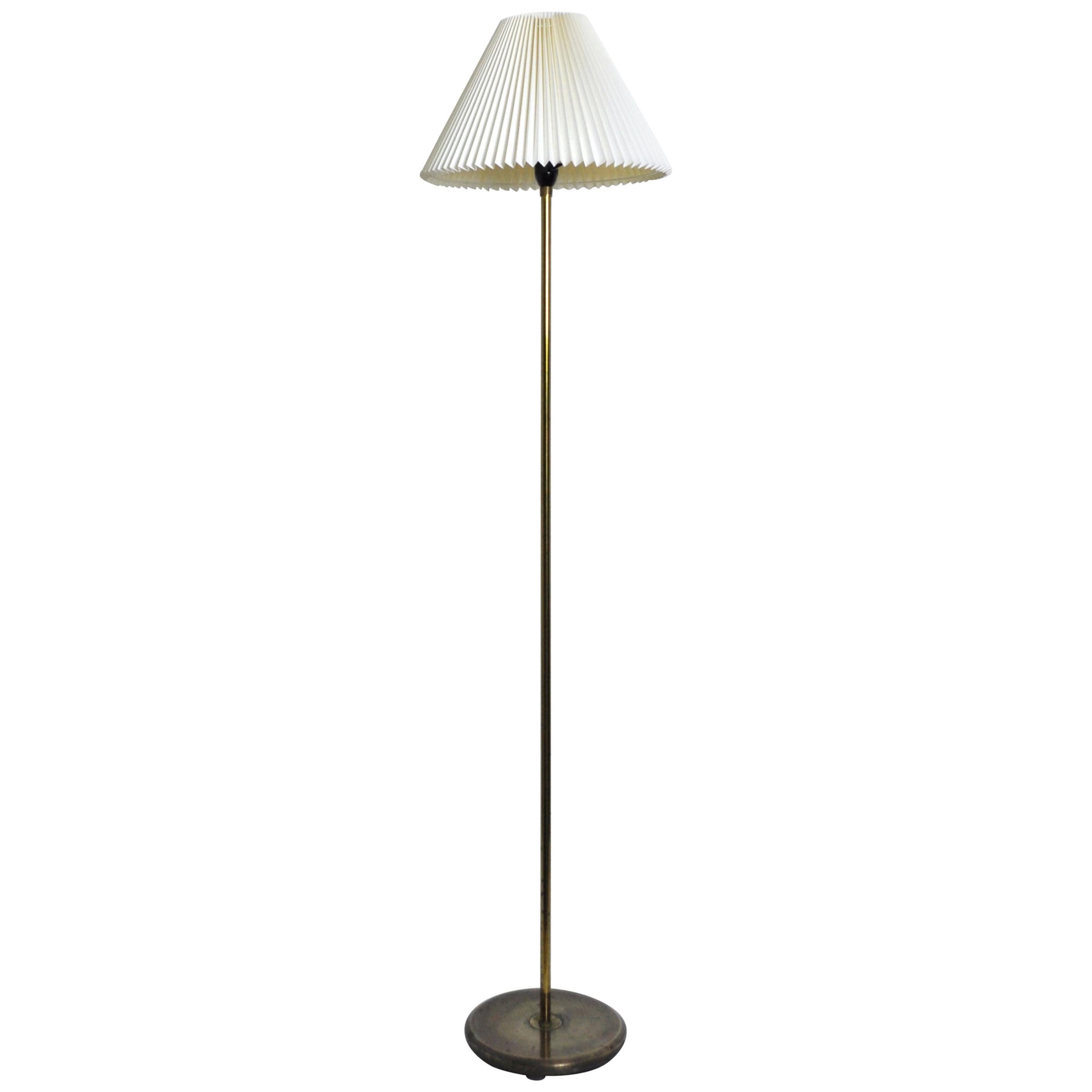 Danish midcentury brass floor lamp. Good condition with a fine patination. Can be delivered with the Le Klint shade which has some wear. 

Dimensions of shade: 14 x 40 x 24 cm.