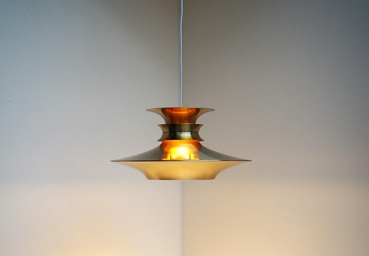 Classic brass pendant with a great shape and warm illumination - Danish vintage lighting designed by Bent Nordsted and manufactured by Lyskær in the 1970s. The lamp is called 