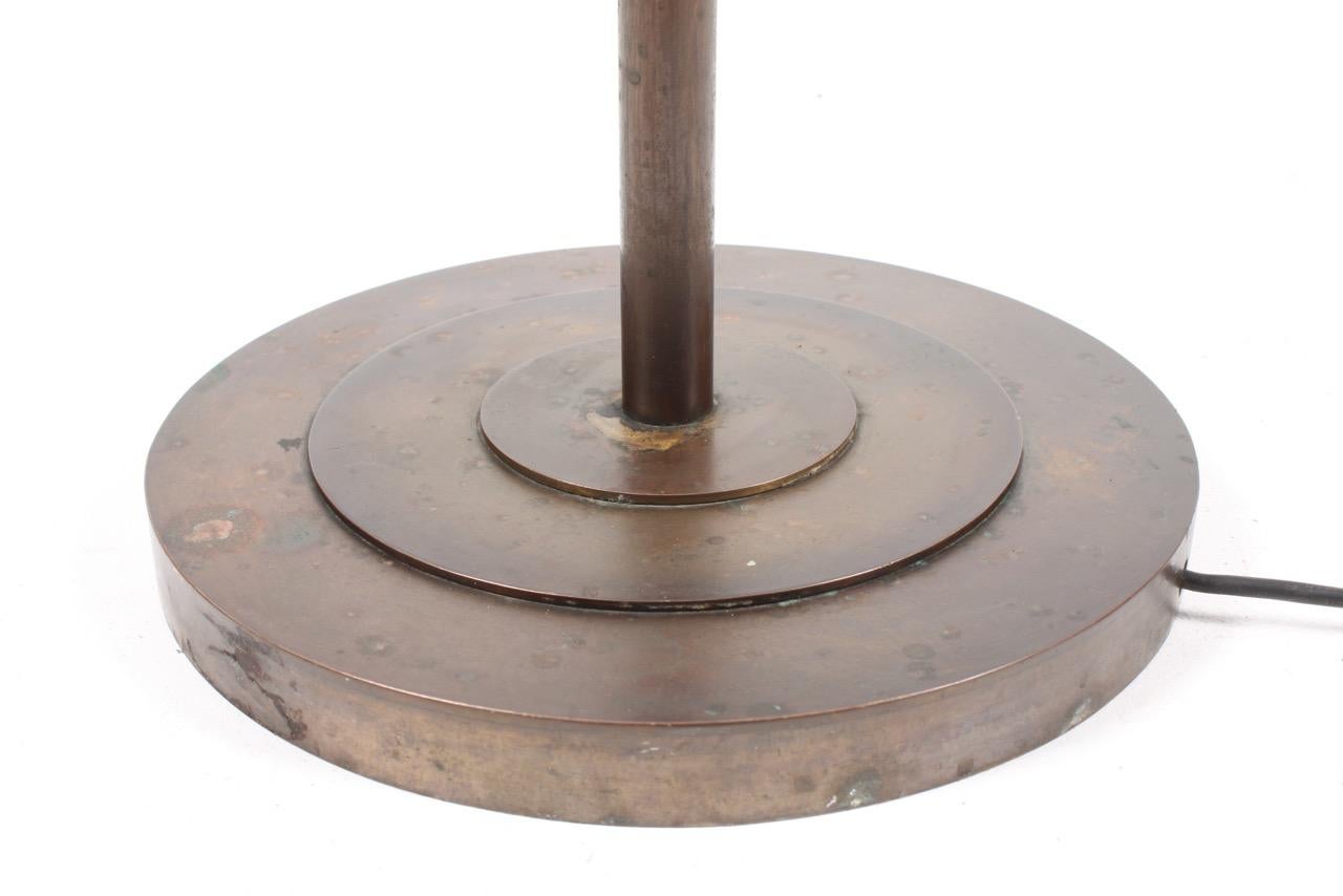 Danish uplight floor lamp in solid patinated brass. Designed and made in Denmark in the 1940s. Great quality.
