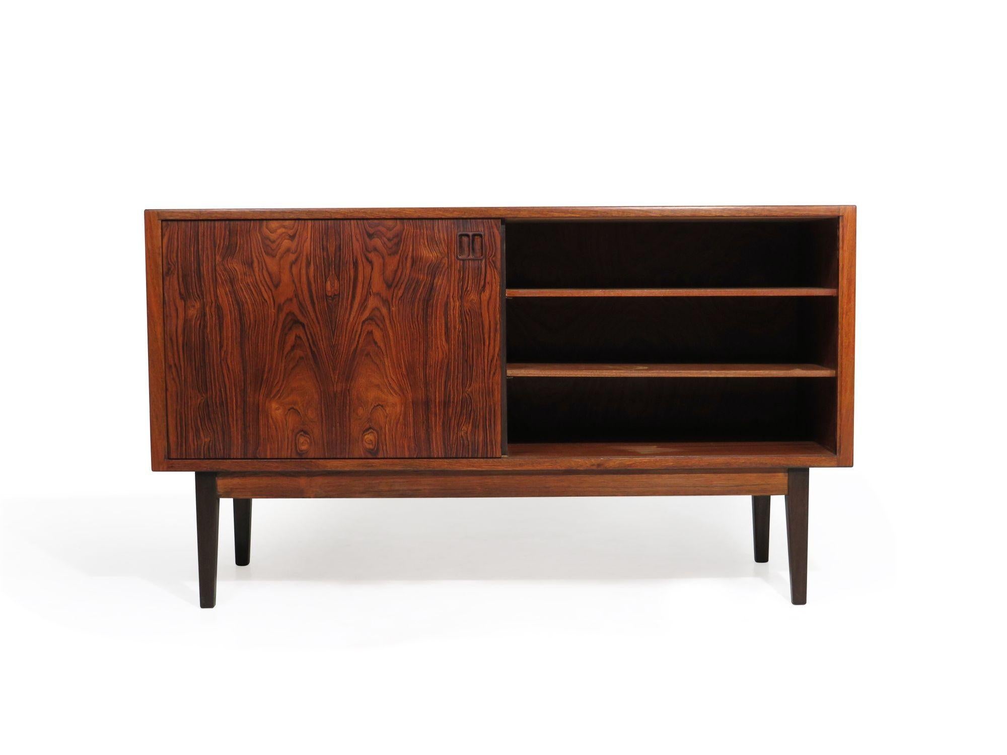Danish Brazilian Rosewood credenza with book-matched sliding door and four drawers with carved pulls. Professionally restored by our team of in-house craftspeople.