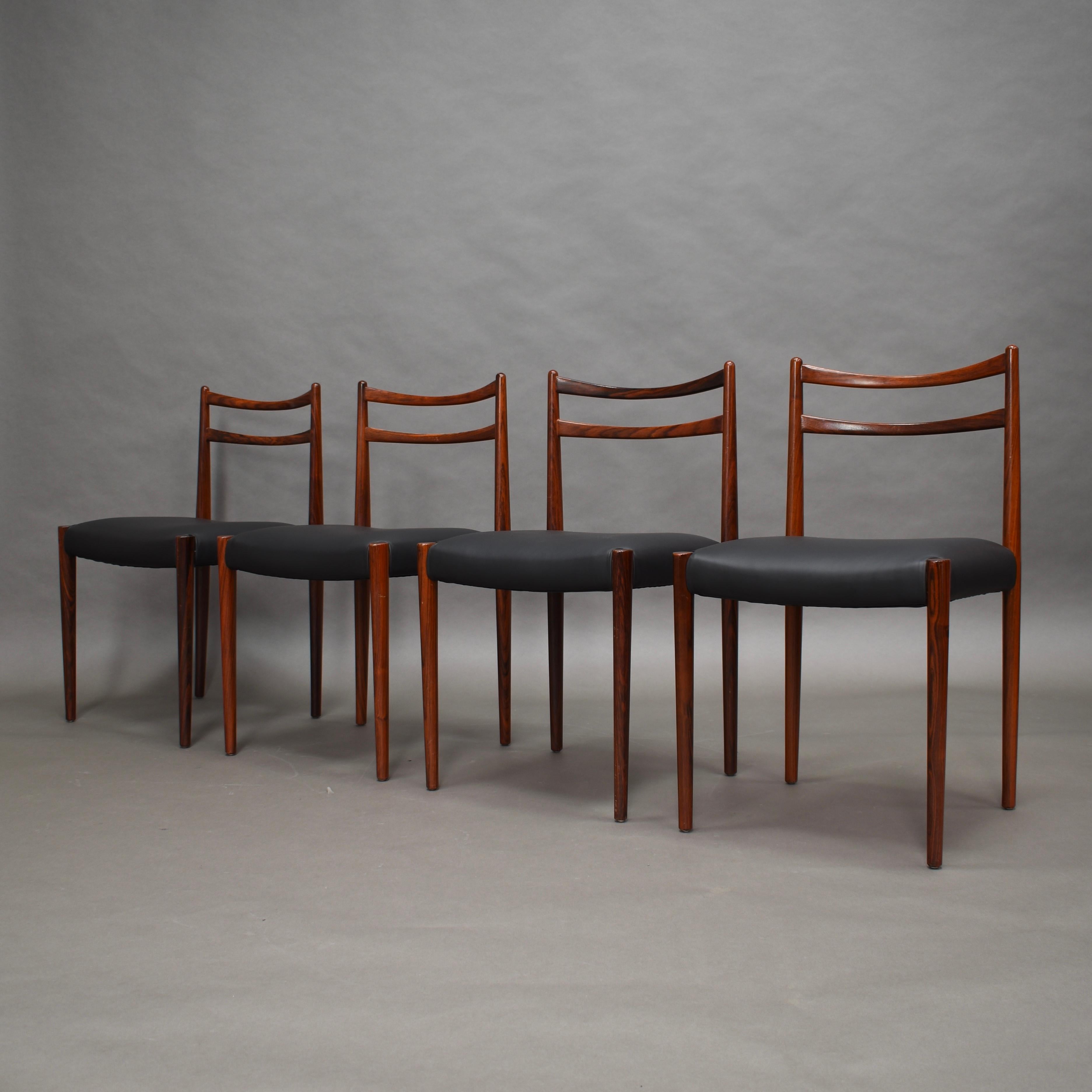 Elegant and organic shaped Scandinavian Danish dinner chairs from the 1950s.
The chairs are made of solid Brazilian rosewood (Rio Palissander) and feature tapered legs and new upholstered seats in beautiful black calf skin leather.
The chairs are