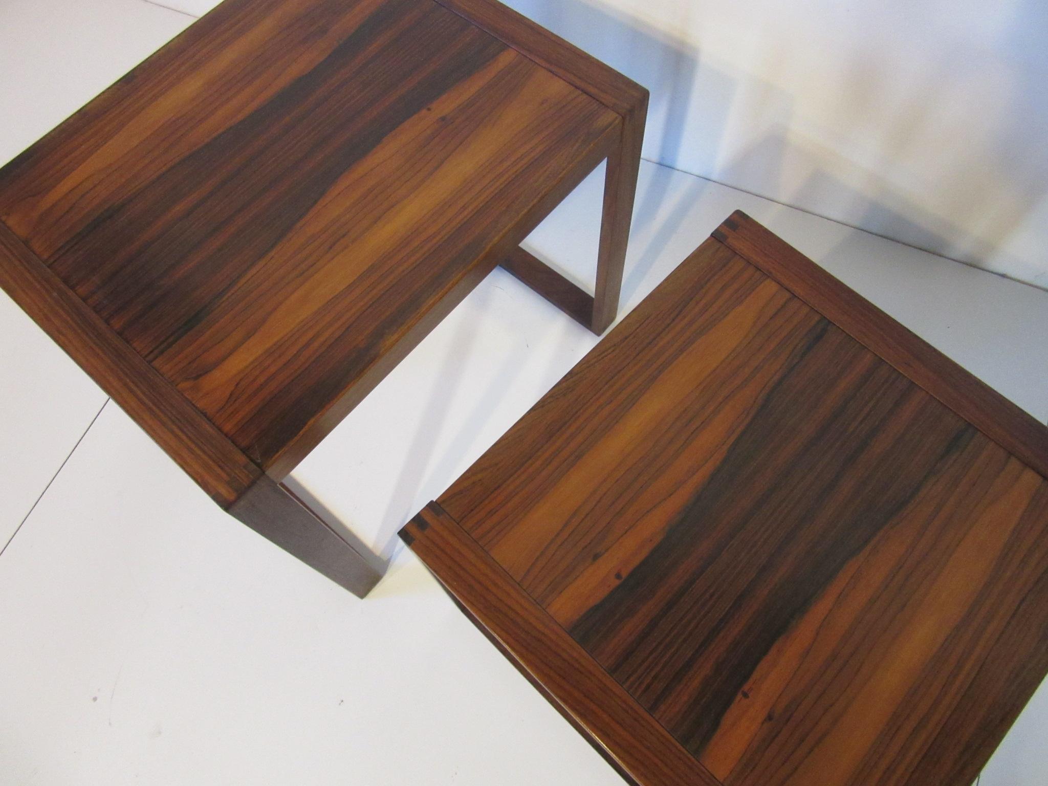 A pair of side tables that can be nested crafted from rich Brazilian rosewood with a
wonderful grain and designed in a simple style. Made in Denmark with the smaller table measuring 16.88