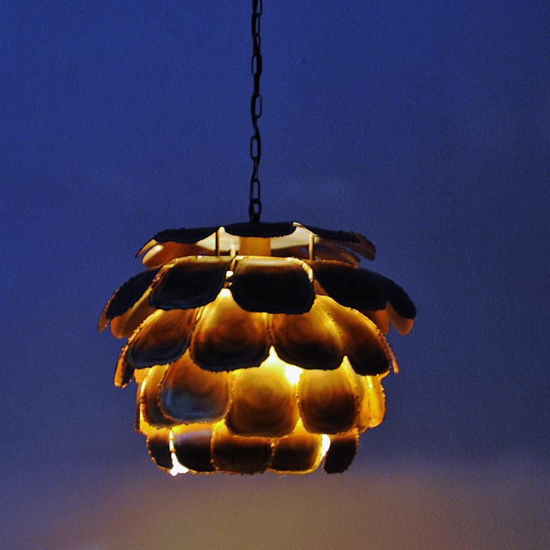 A stunning mid-century Danish brutalist ceiling pendant designed in the 1960s by designer Svend Aage Holm Sørensen for Holm Sørensen & Co AS. This vintage brass lamp has an acid-treated and torch-cut look in a brutalistic design. It gives a lovely