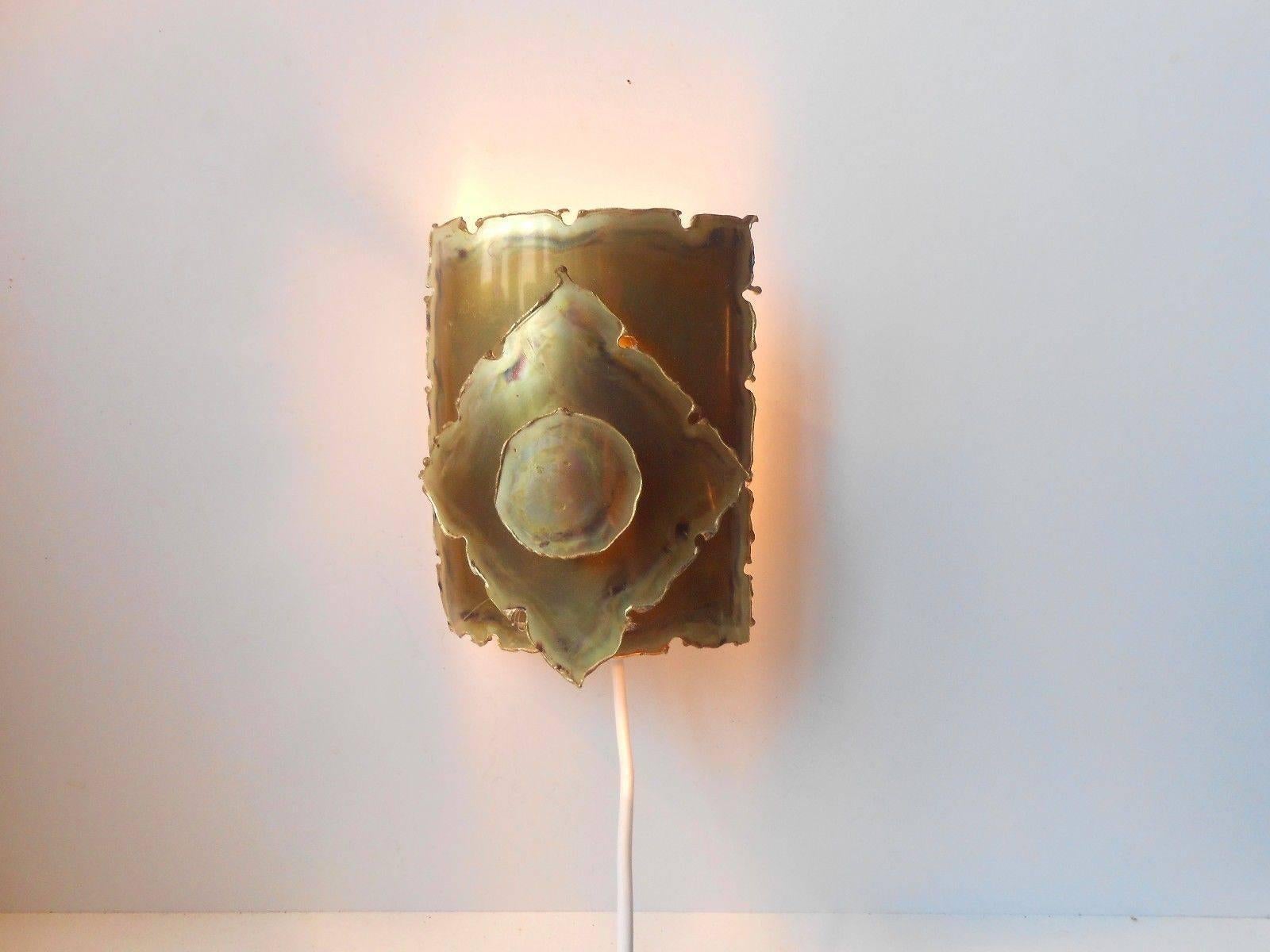 Torch cut, acid treated and patinated wall sconce manufactured by Holm-Sorensen Belysning, Copenhagen, circa 1960. Measurements: H 7.25, W 5.75 inches. Condition: Near mint.
