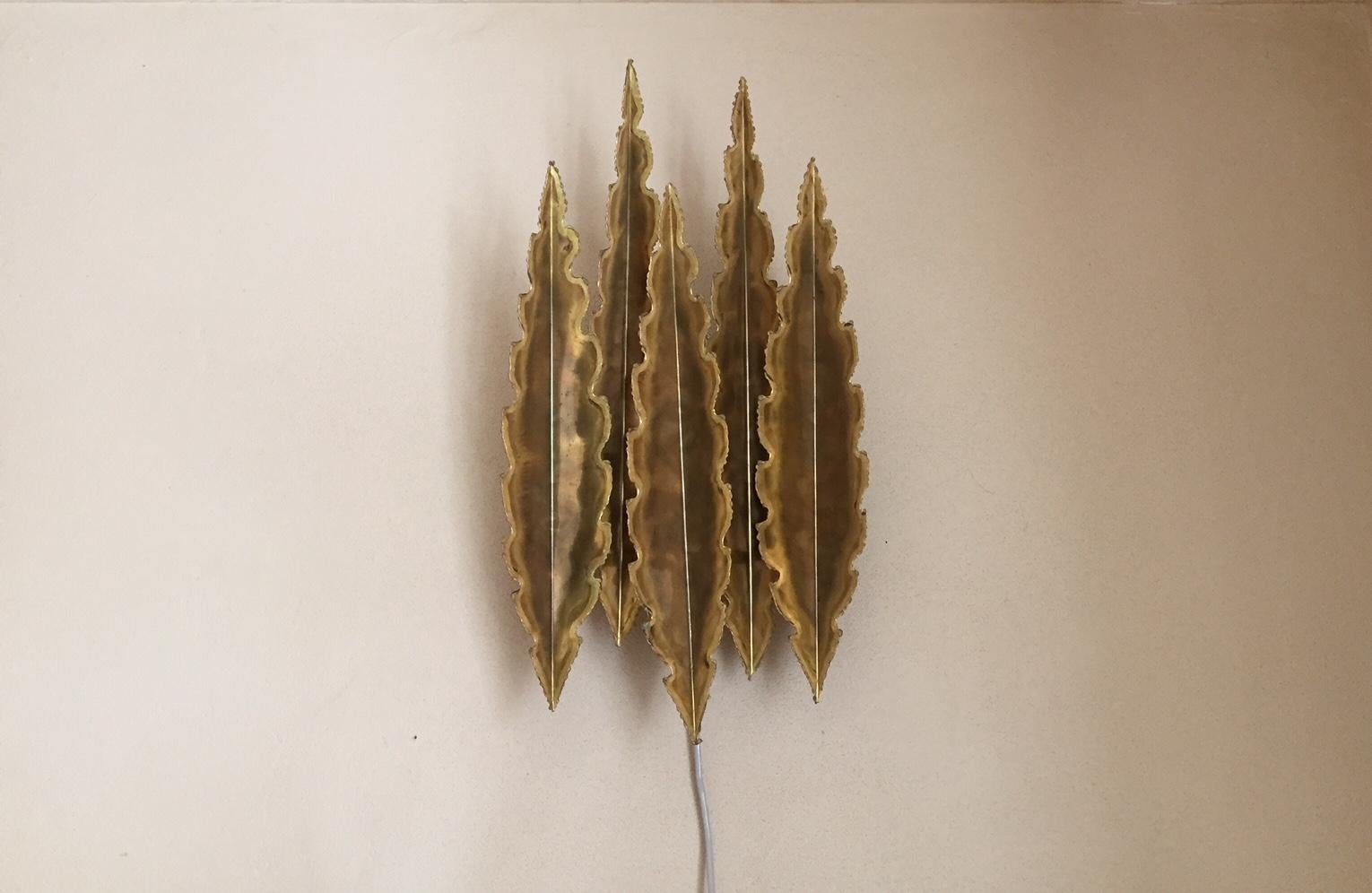 This large (57/30 cm) Danish Brutalist wall light is composed of partially acid-treated and torch-cut brass. This model 5195 was designed by Svend Aage Holm Sørensen in Denmark during the early 1960s. The shade resembles flames - five to be exact.