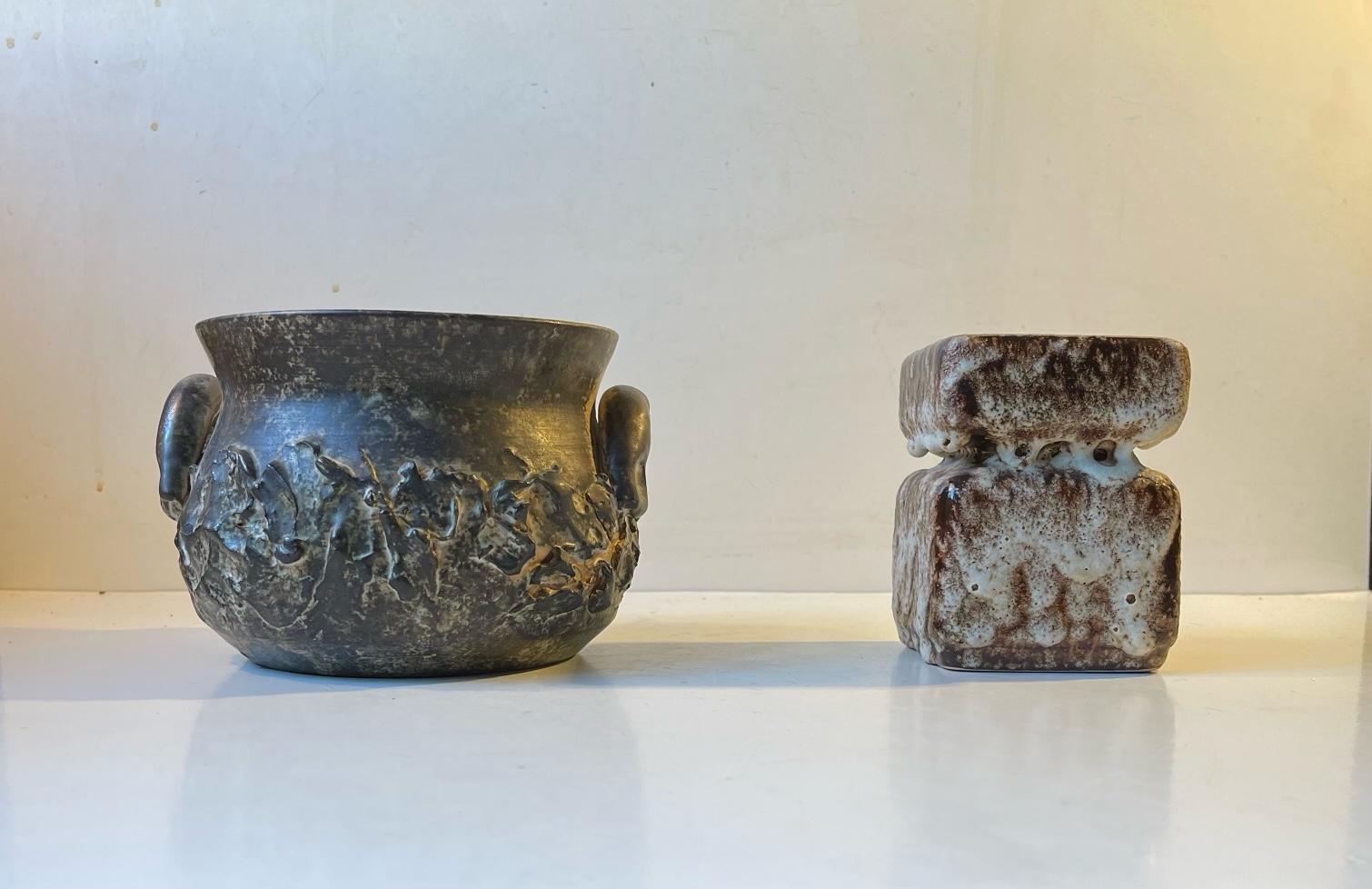 Curated set of 2 ceramic pieces. A pot shaped bowl/planter from Dot keramik in Denmark circa 1970 and an unknown square fat-lava vase or small planter from the the early 1970s. The style of these is brutalism. Measurements: Bowl: 12x15 cm, Vase: