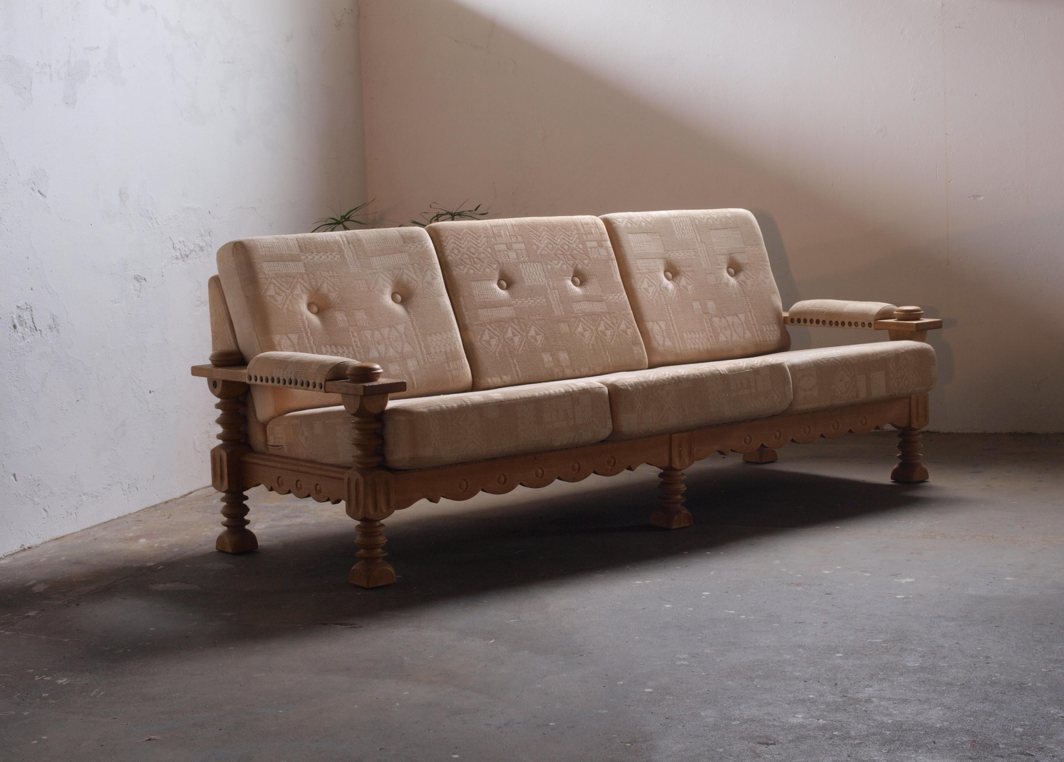 Beautiful brutalist 3/4-seater sofa attributed to Henning Kjærnulf. The beautiful turned legs give it a rustic expression. Solid oak frame in almost perfect condition.

The item is produced in Denmark in the 1960s. Extremely sculptural. Its low back
