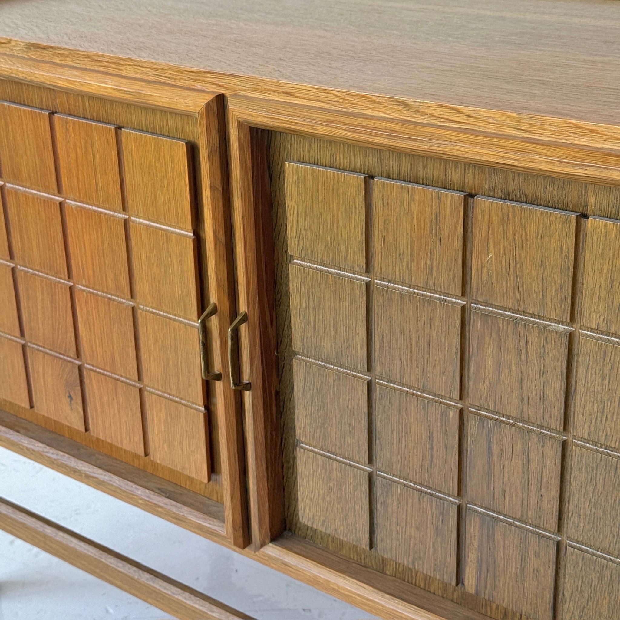 c. 1980s. Denmark. Brass pulls and full wood construction with two tone stained doors. 

