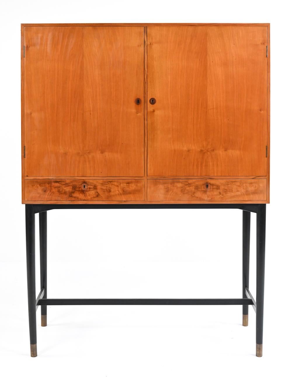 Fine craftsmanship and luxurious details abound in this exquisite tall server cabinet. Two bookmatched mahogany doors open to reveal ample shelving and an easily adjustable modular tray system for flatware storage. Each tray is felt lined, with