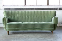 Danish Ca. 1950 Curved Sofa in Green Mohair and Brass Capped Legs