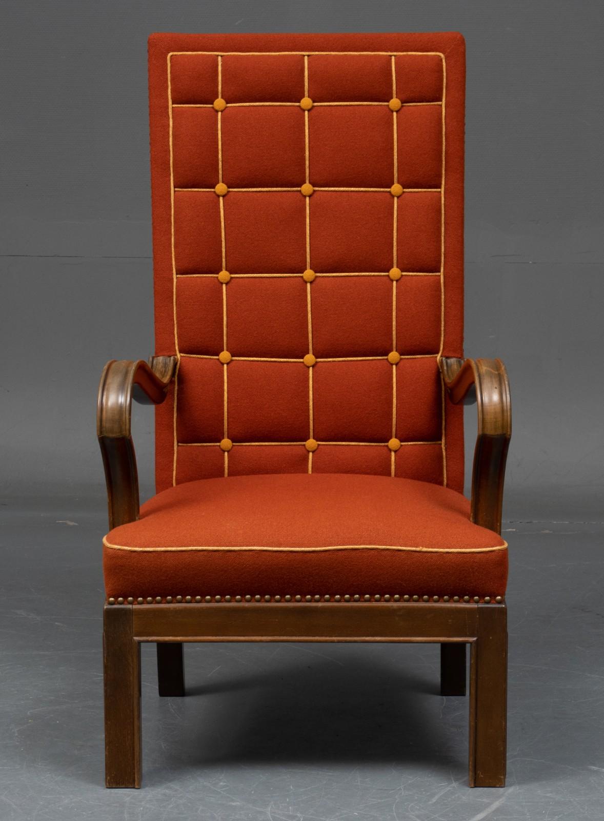 High-backed Danish modern armchair in later upholstery with dark orange Hallingdal furniture fabric from Kvadrat, designed by Nanna Ditzel. Buttoned back in squares with yellow bores. Seamless edges. Armrests and frame in stained beech.